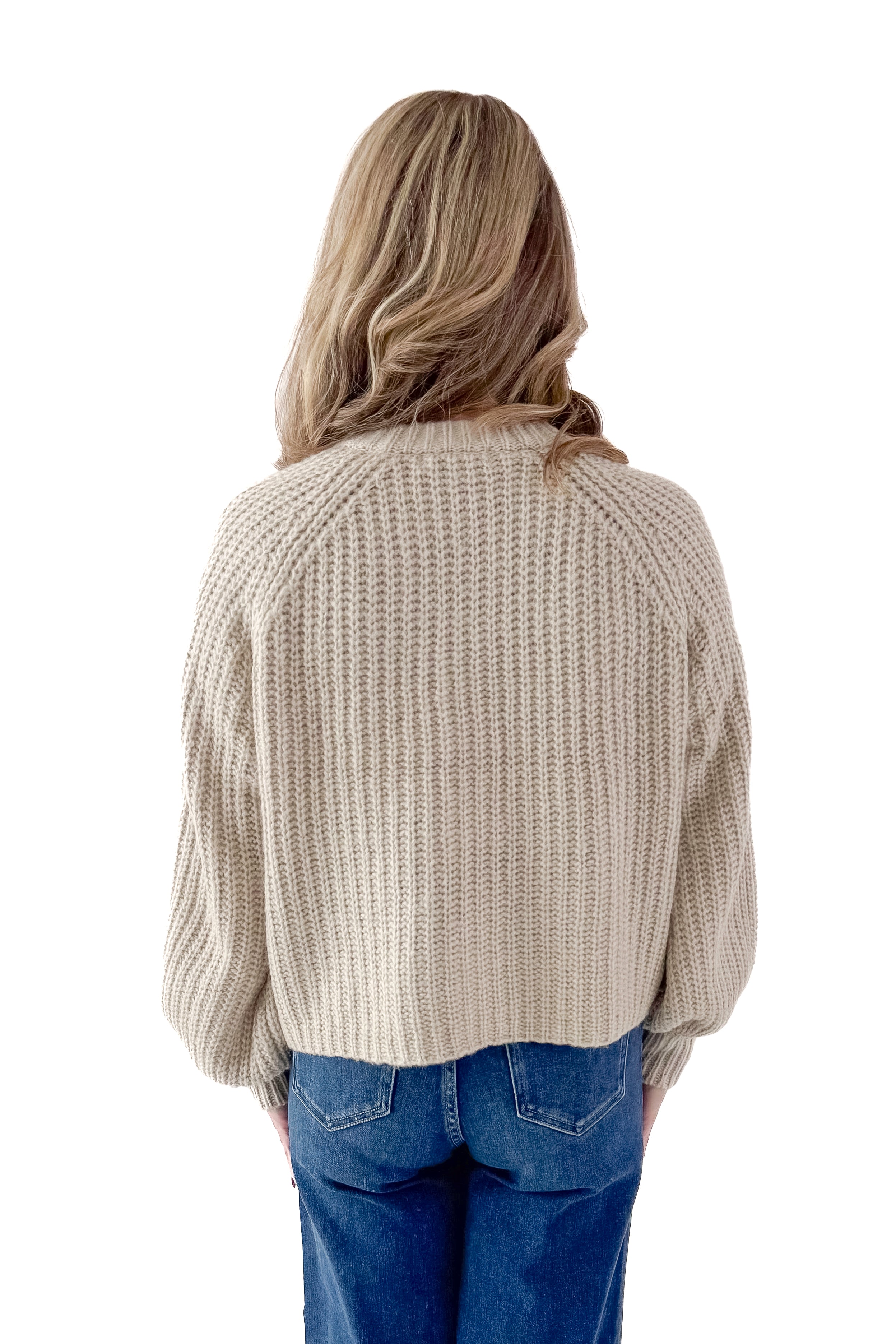 Back view of woman wearing Light Mocha Button Up Cardigan with jeans against white studio background.