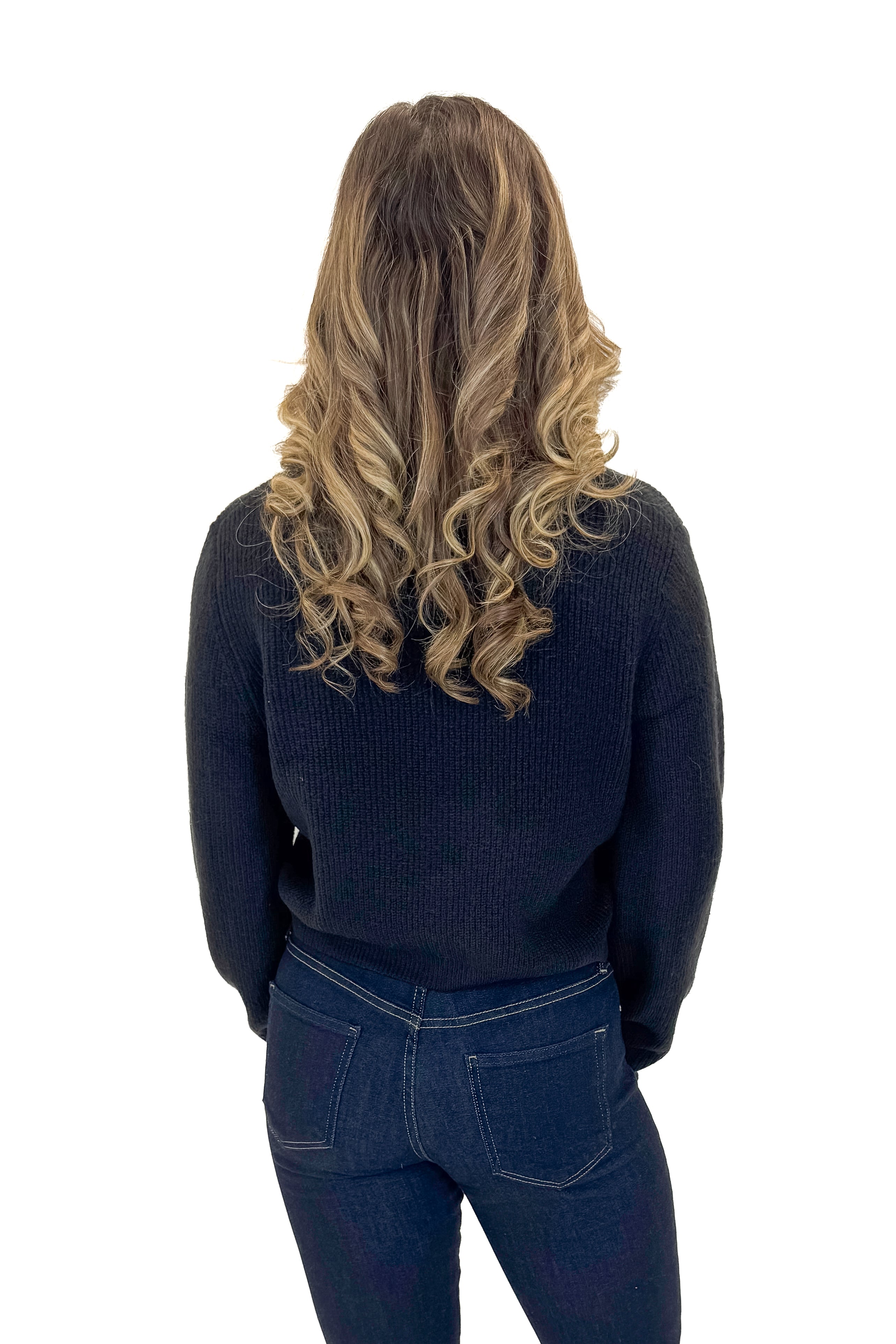 Back view of woman wearing Black Cardigan With Rhinestone Bow with jeans against white studio background.