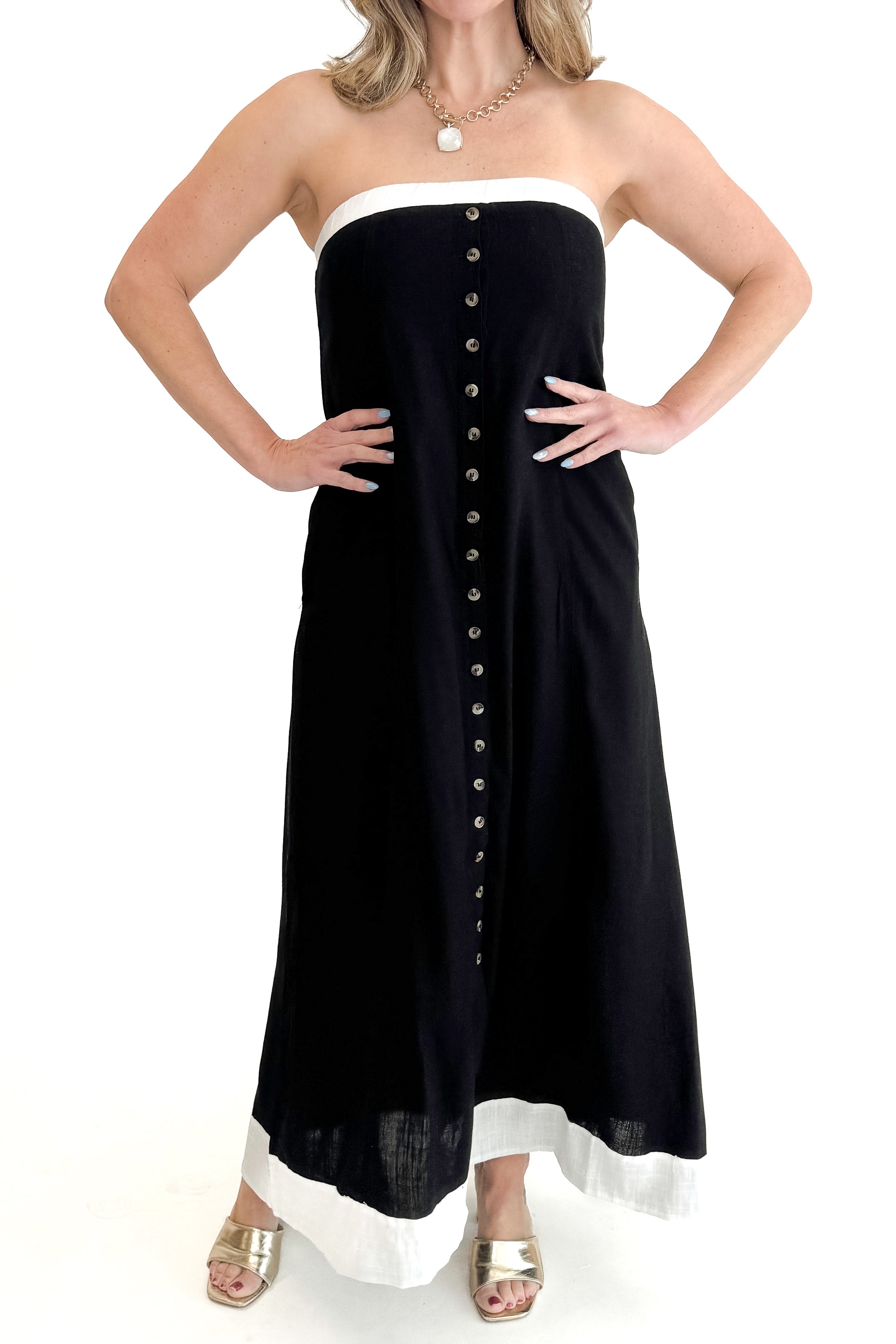 Front view of woman wearing Black With White Lining Button Down Strapless Dress against white studio background.