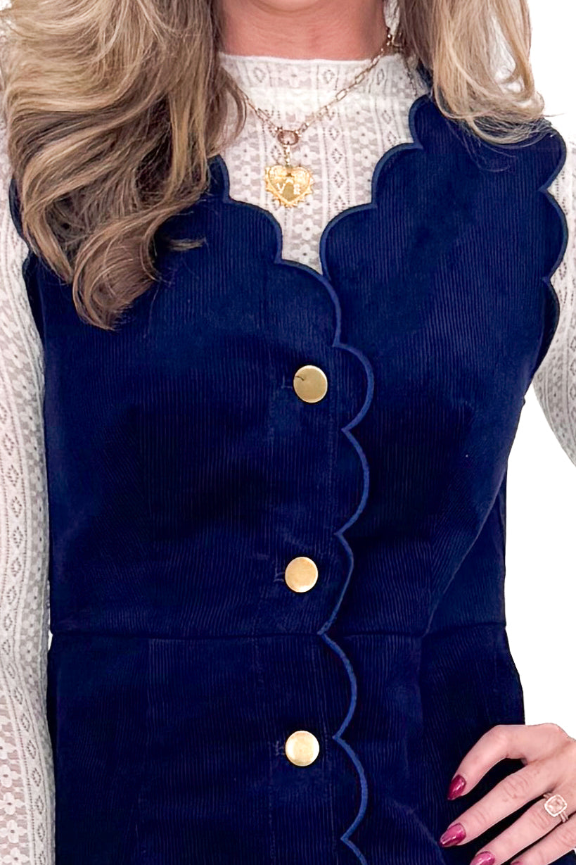 Front detailed view of model wearing Navy Corduroy Scallop Lined Dress with boots against white studio background.