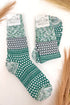 green and white patterned socks against a white background