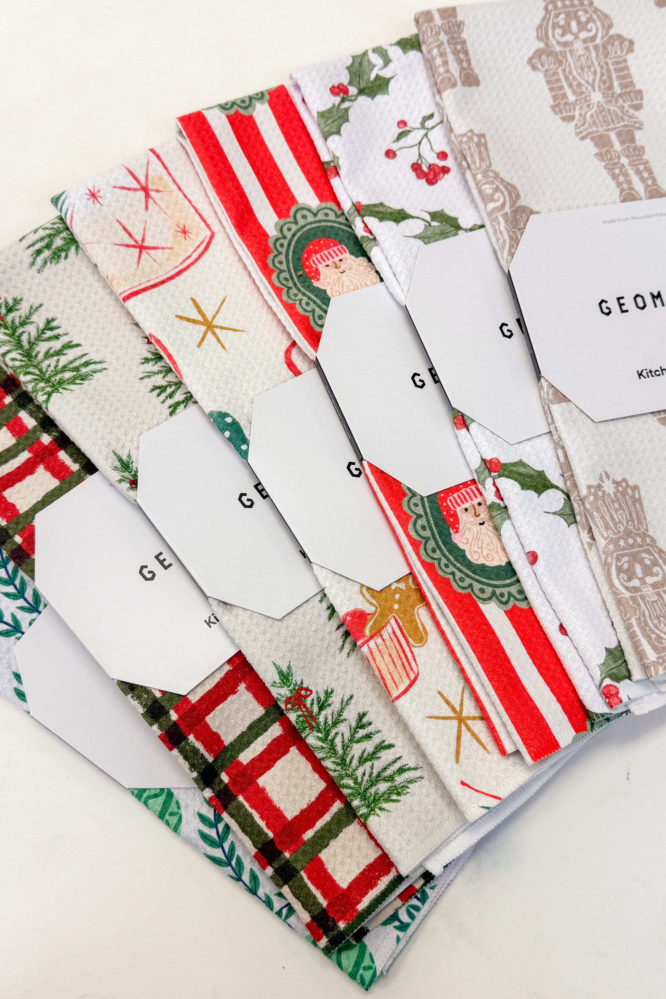 Collection of towels with various patterns on a white background