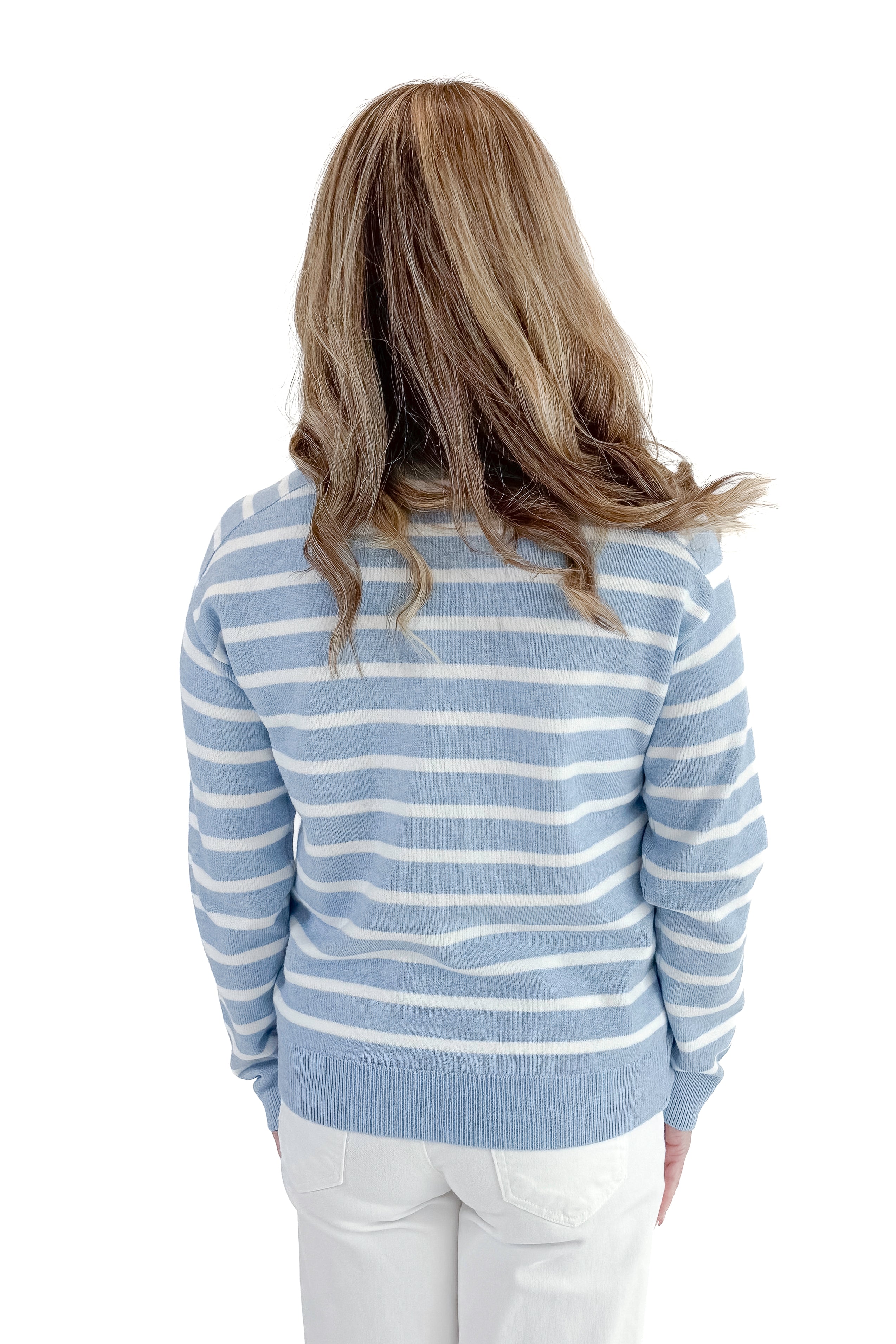 Back view of woman wearing Light Blue Striped Sweater with jeans against a white background.