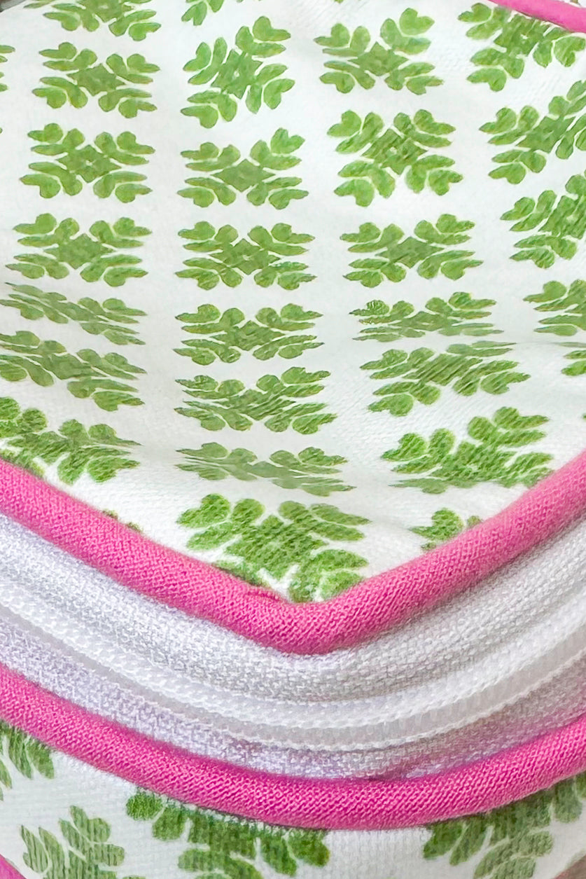 Close-up of a fabric with green leaf pattern and pink border