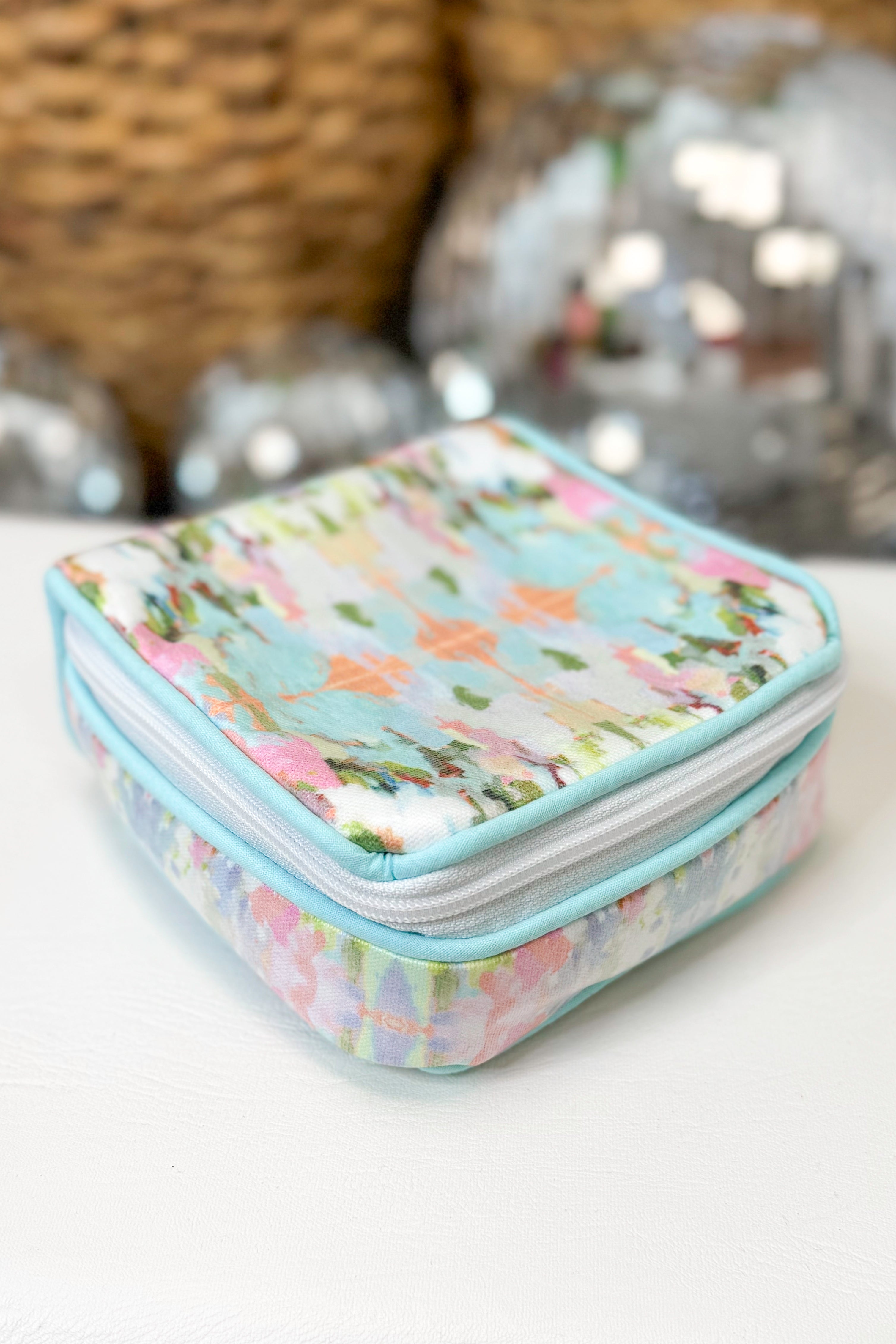 Small rectangular pouch with floral pattern on a white surface