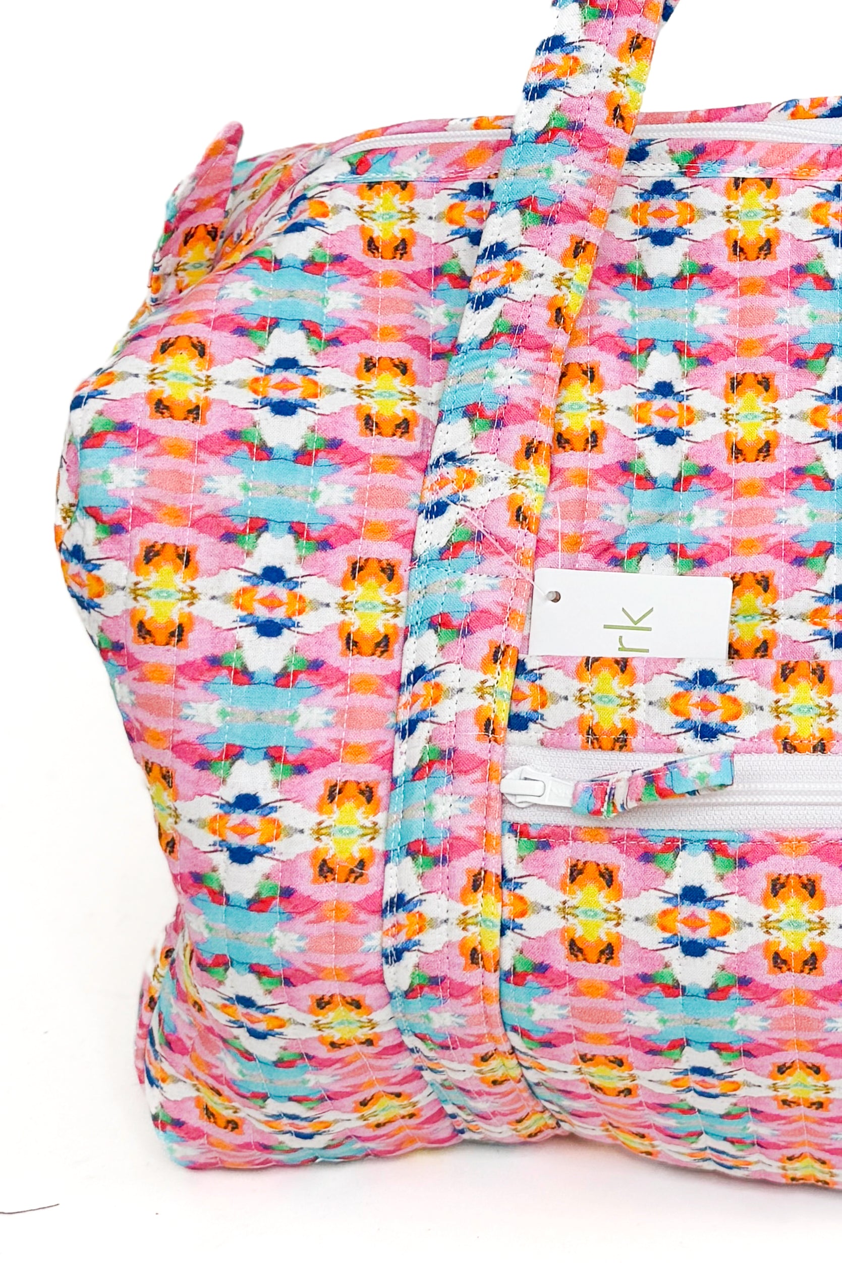 Multicolored patterned bag with a visible brand logo on a white background