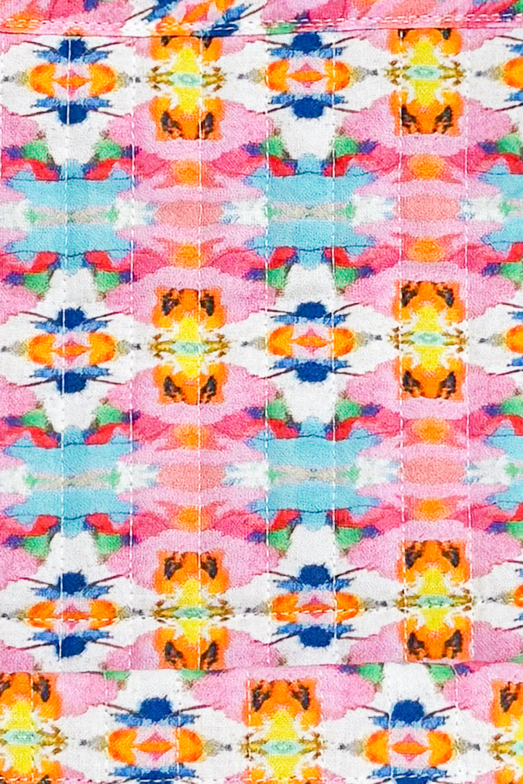 Colorful abstract pattern with flowers and geometric shapes on a pink background