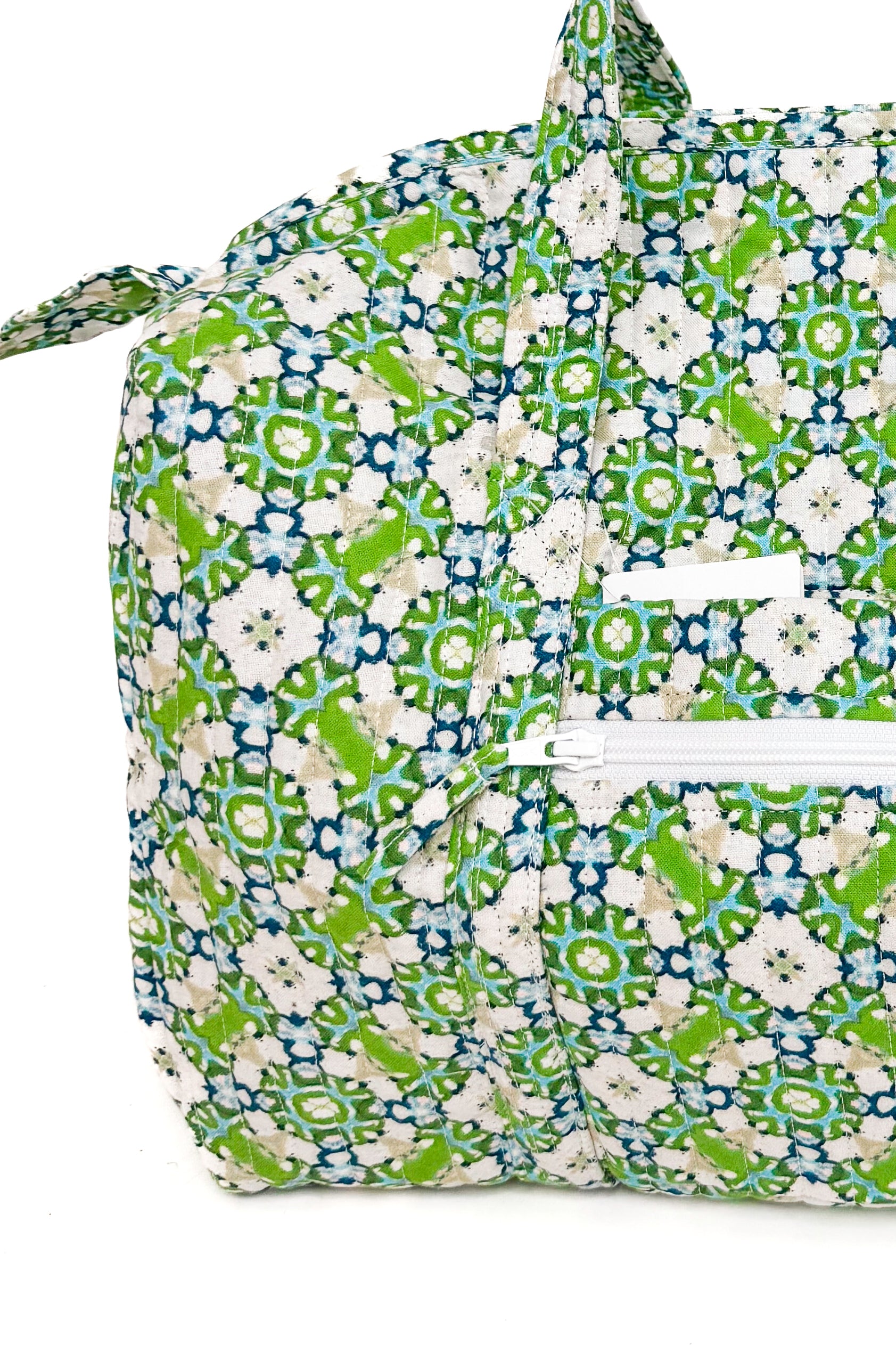 Floral patterned bag with green and white flowers on a white background