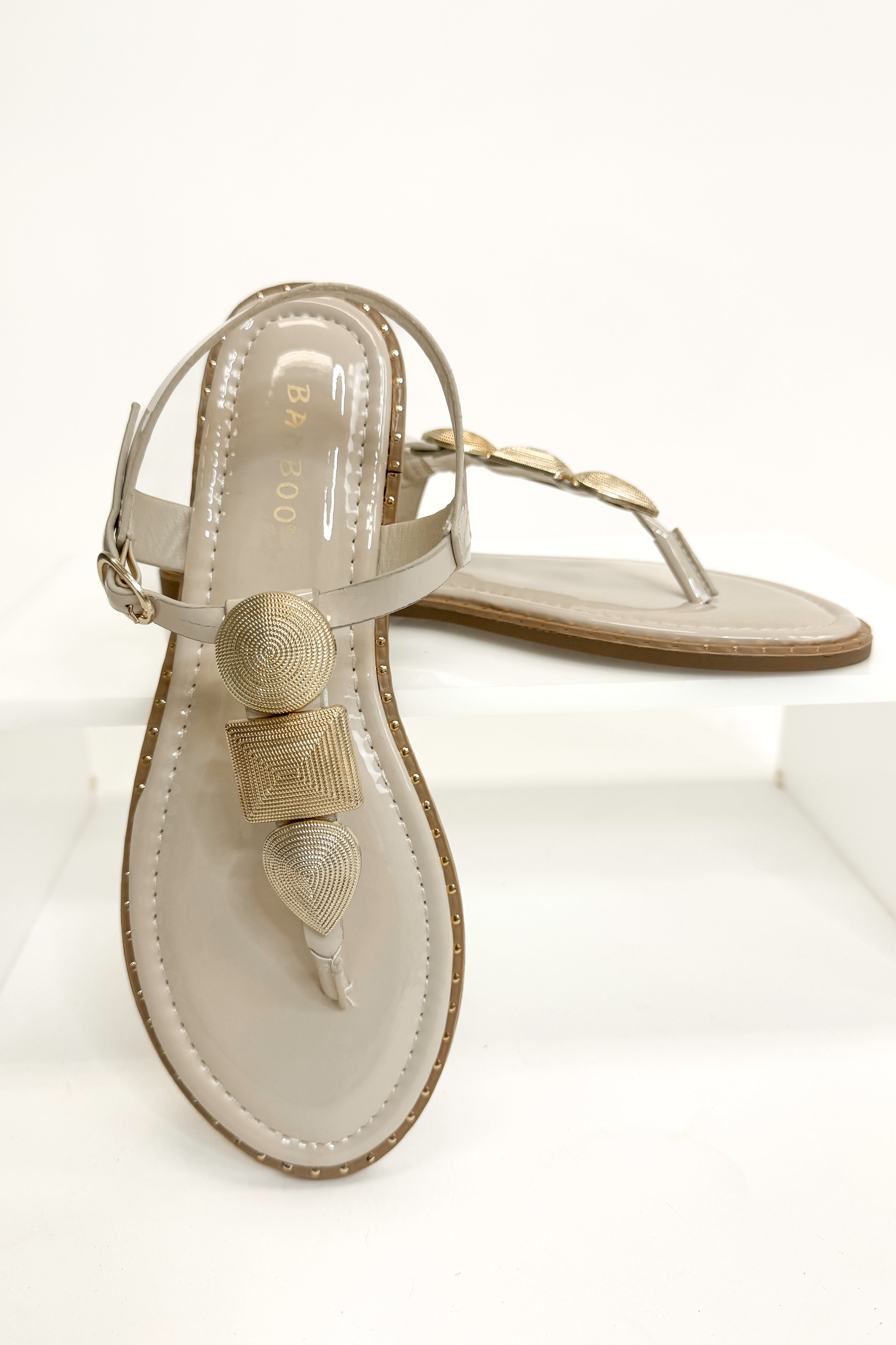 Twinkle- Bone With Gold Charms Sandal against white studio background front and side view.