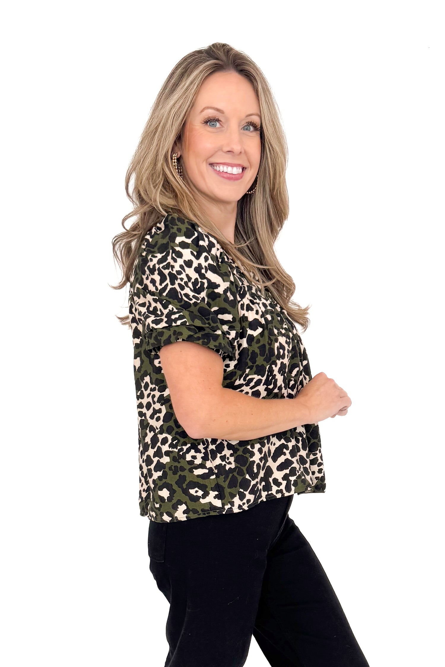 Woman wearing a leopard print top on a white background
