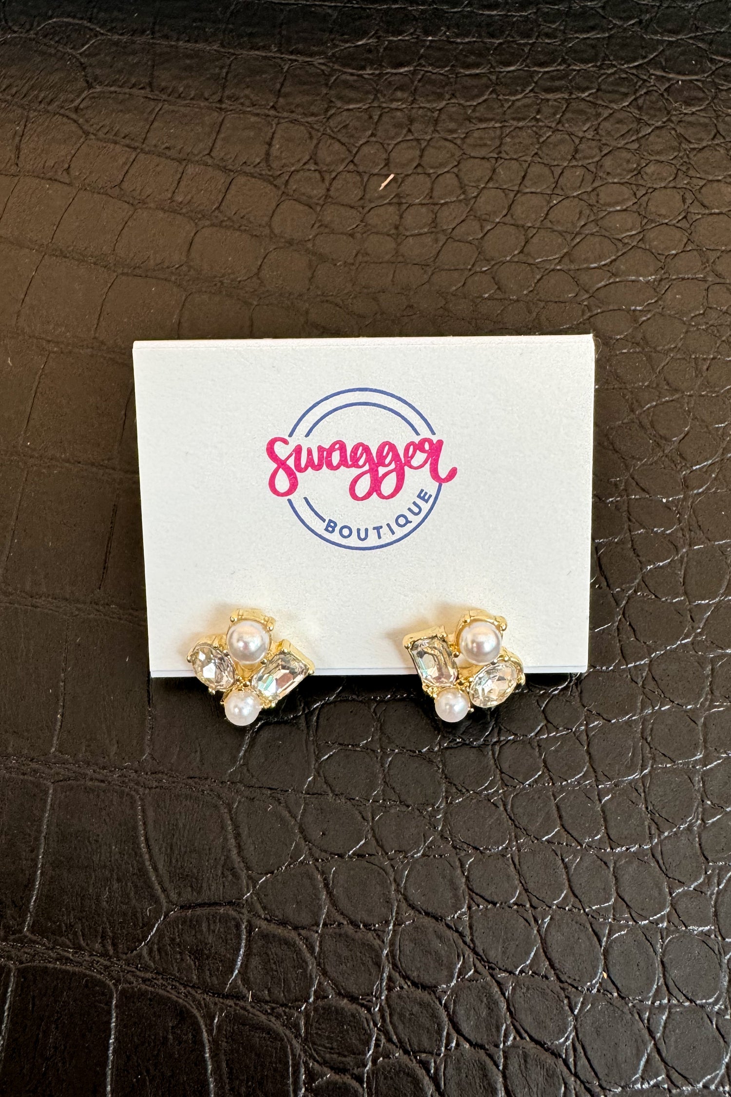 Gold earrings on a card with &
