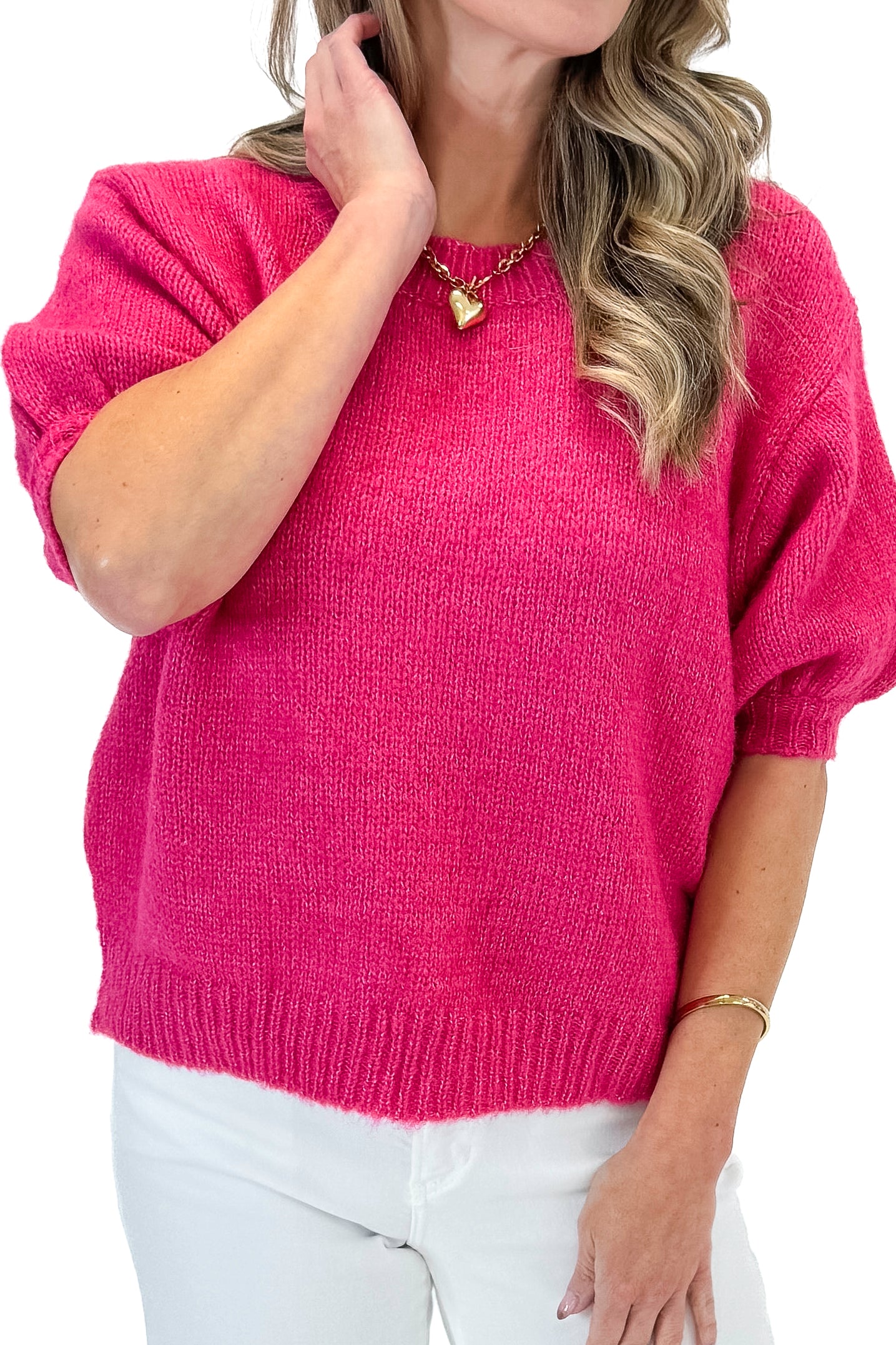 Front detail view of woman wearing Hot Pink Short Puff Sleeve Sweater with jeans against white studio background.