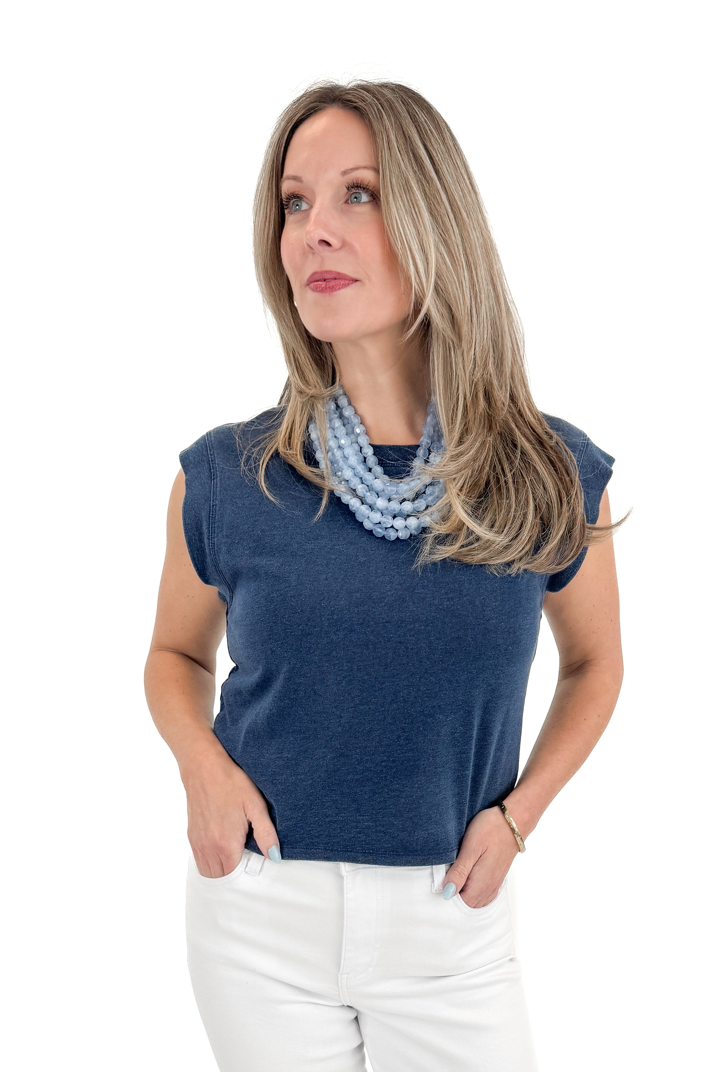Front view of woman wearing Indigo Camino Jersey Denim Top by Z Supply with jeans against white studio background.