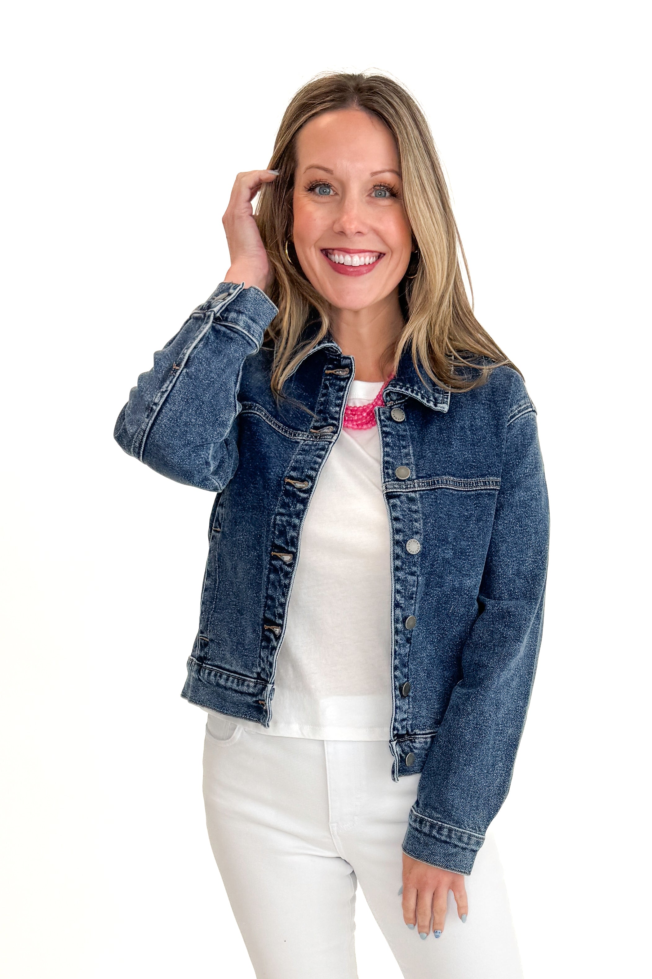 Front view of woman wearing Dark Wash Denim Jacket with jeans against white studio background.