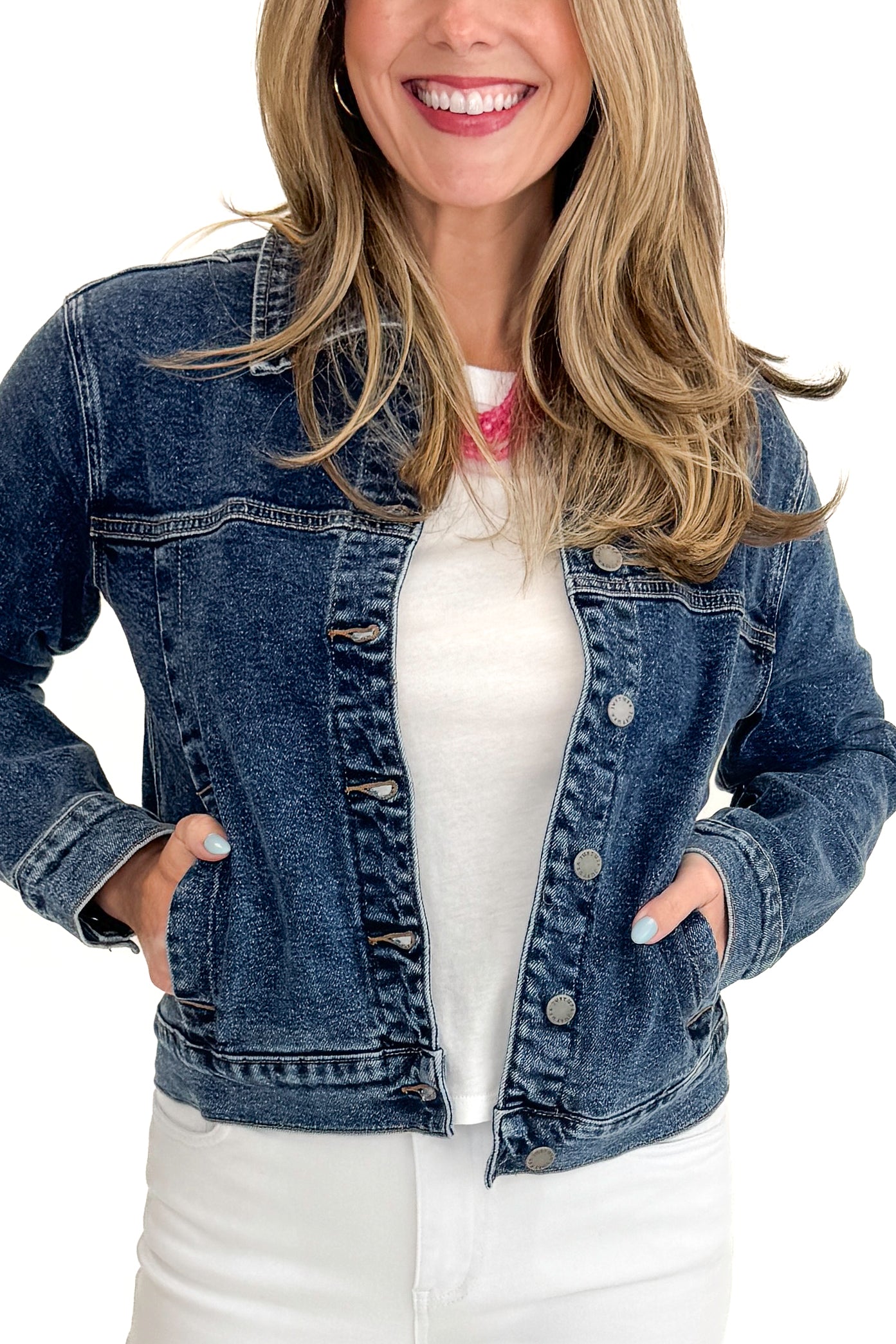 Front detail view of woman wearing Dark Wash Denim Jacket with jeans against white studio background.
