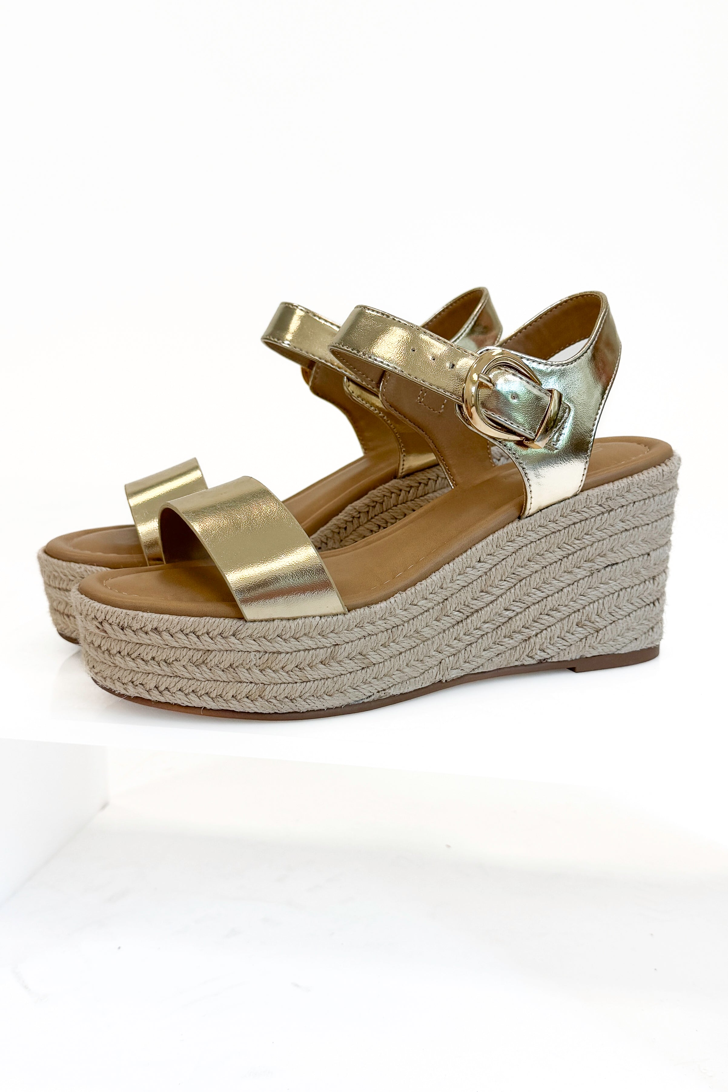 Jena Gold and Rattan Wedge shoes against white studio background.