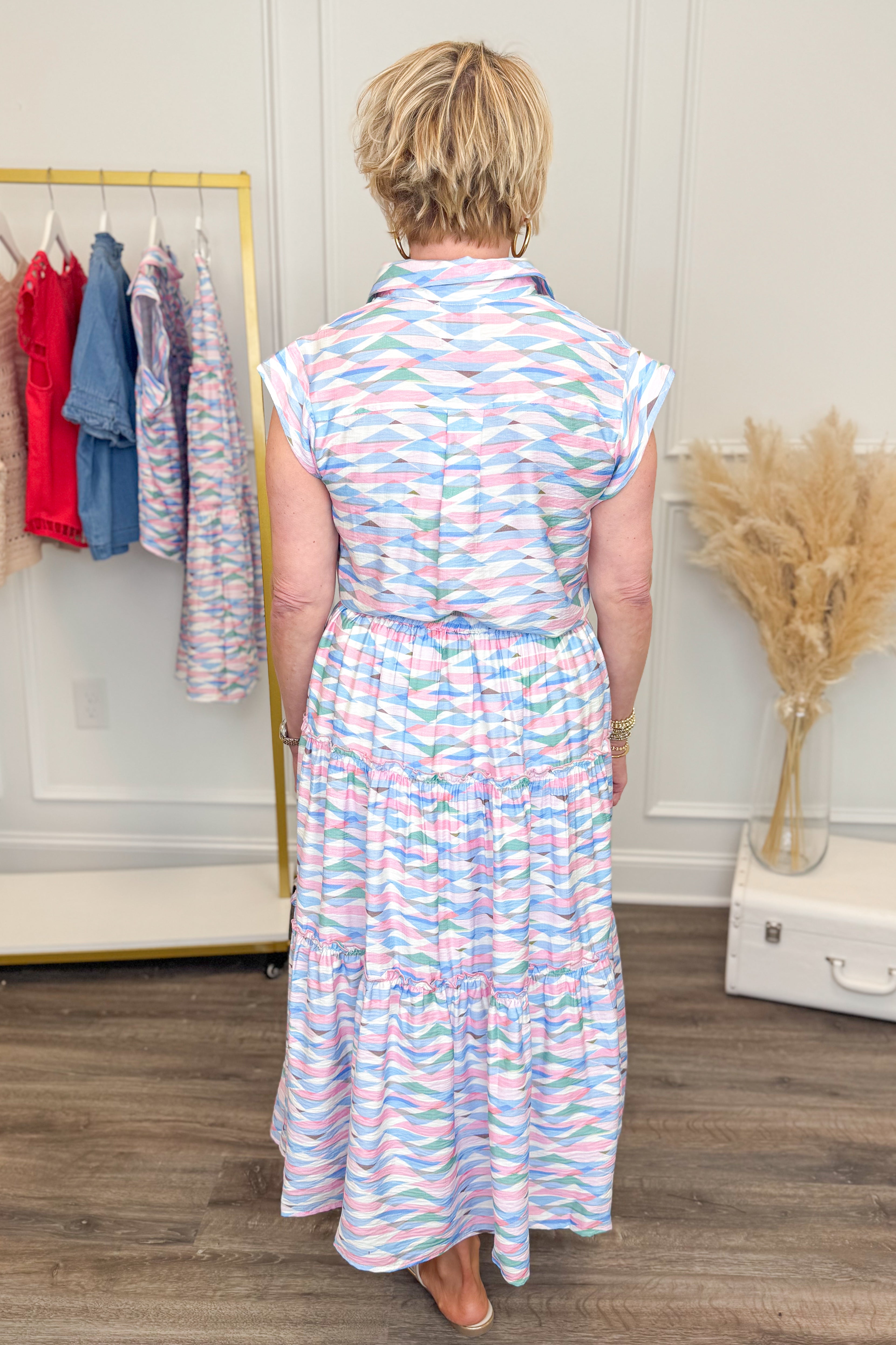 Back view of woman wearing Just A Little Something Pink & Blue Abstract Print Skirt with matching top at Swagger boutique.