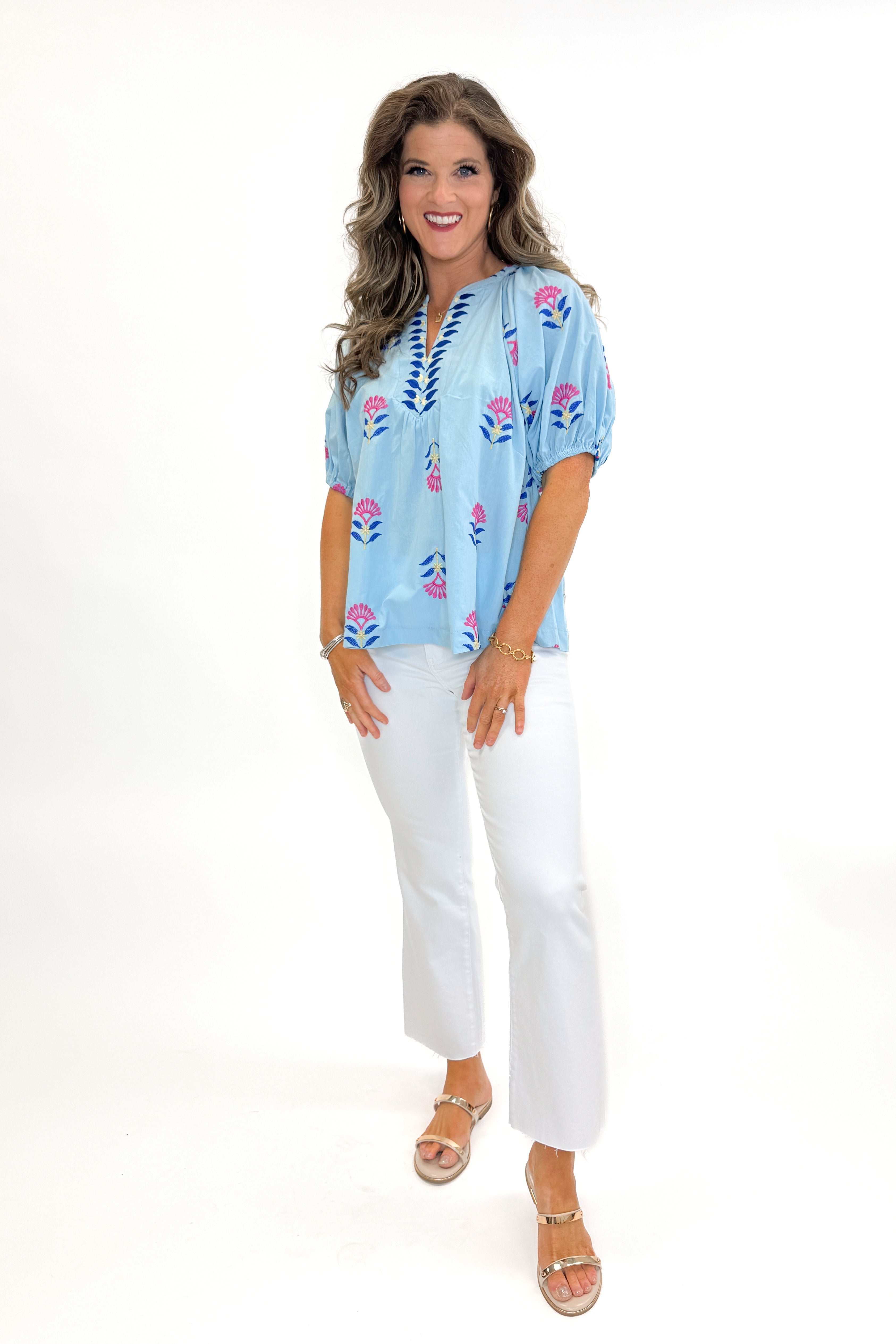 Front view of woman wearing Blue & Multi Floral Embroidered Top with jeans against white studio background.