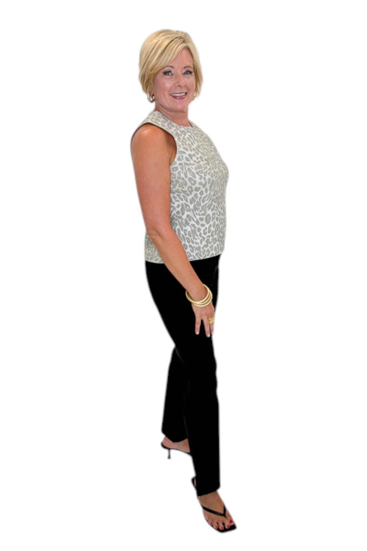 Side view of woman wearing Swagger Boutique’s Kelsey Ankle Flare Jeans In Black by Kut from the Kloth with top against white studio background.