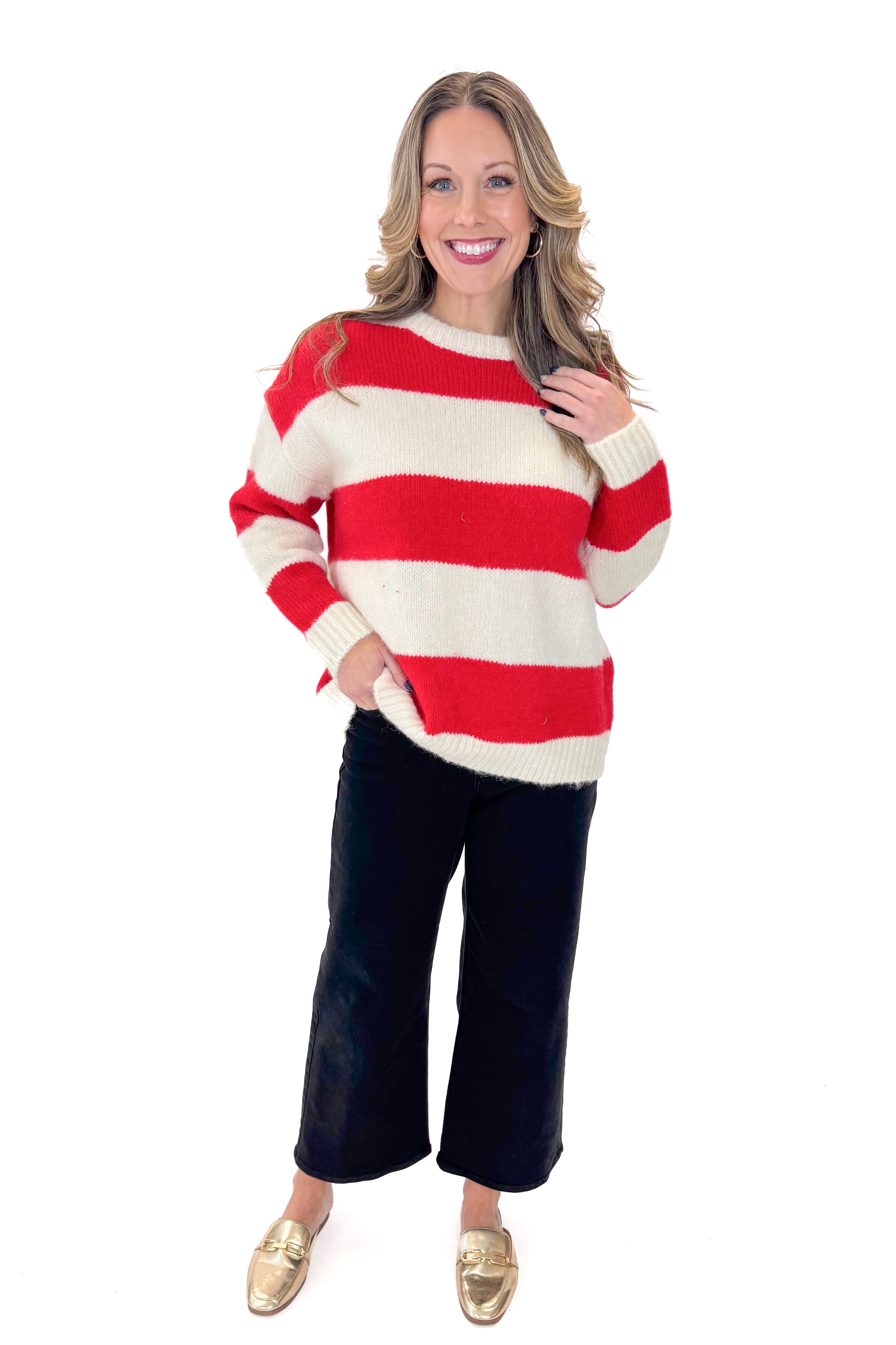 Front view of woman wearing Ivory & Red Striped Sweater with jeans against white studio background.