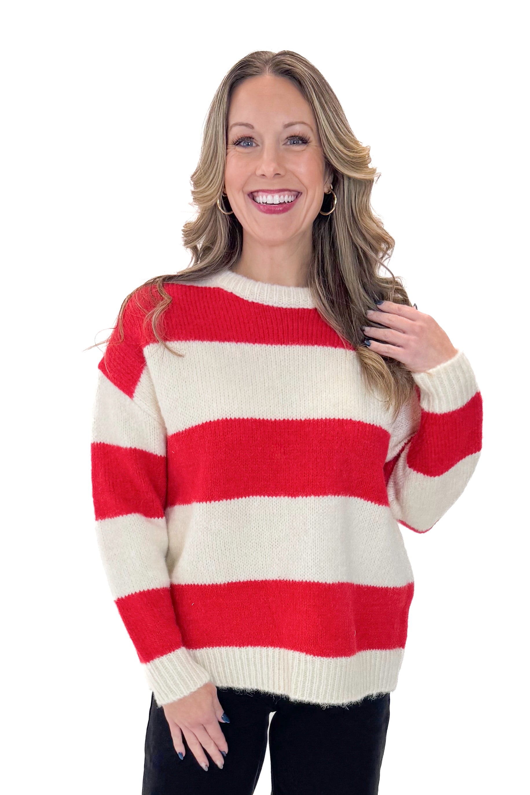 Front view of woman wearing Ivory & Red Striped Sweater with jeans against white studio background.