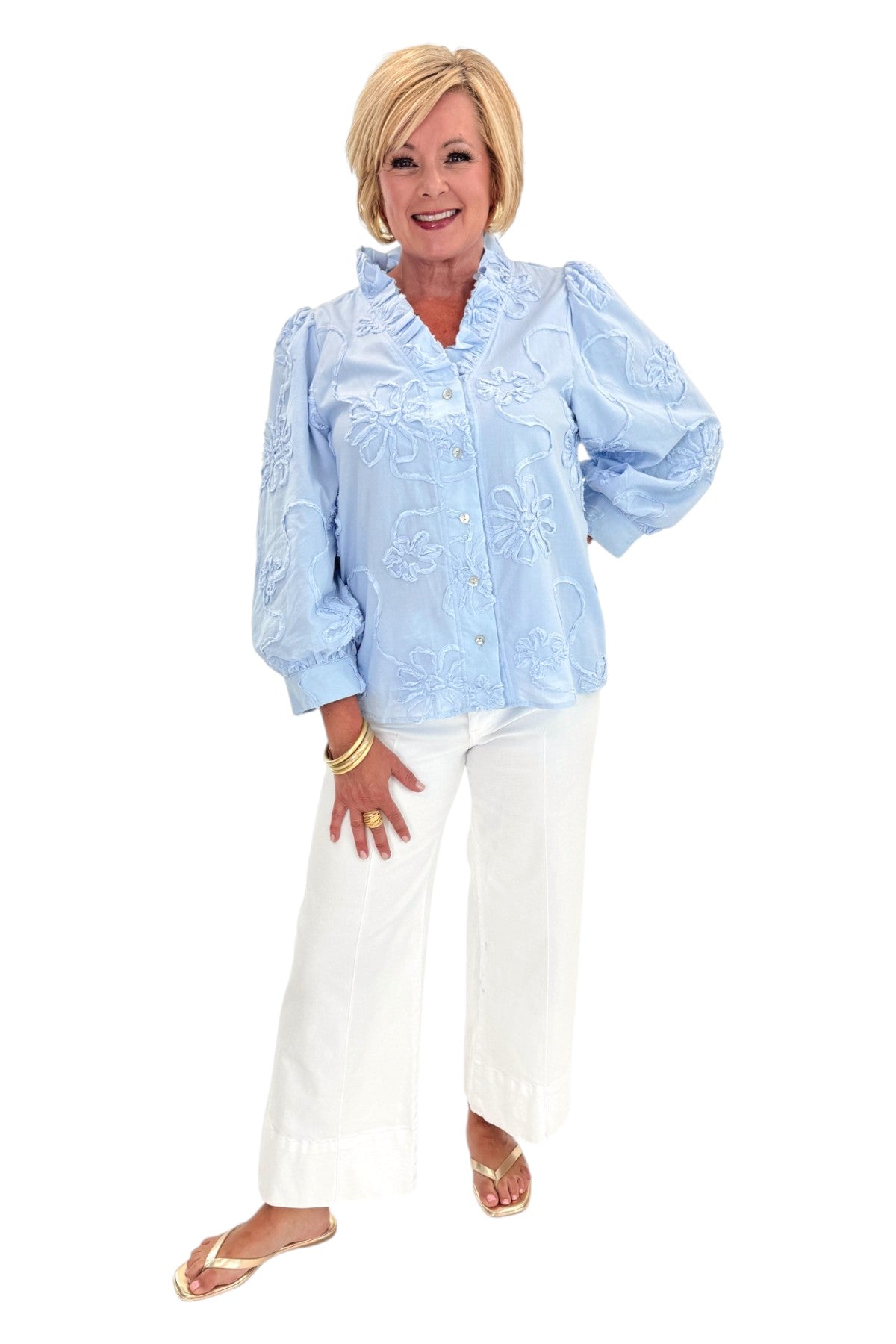 Front view of woman wearing Swagger Boutiqueās Light Blue Floral 3/4 Sleeve Embroidered Top with jeans against white studio background.