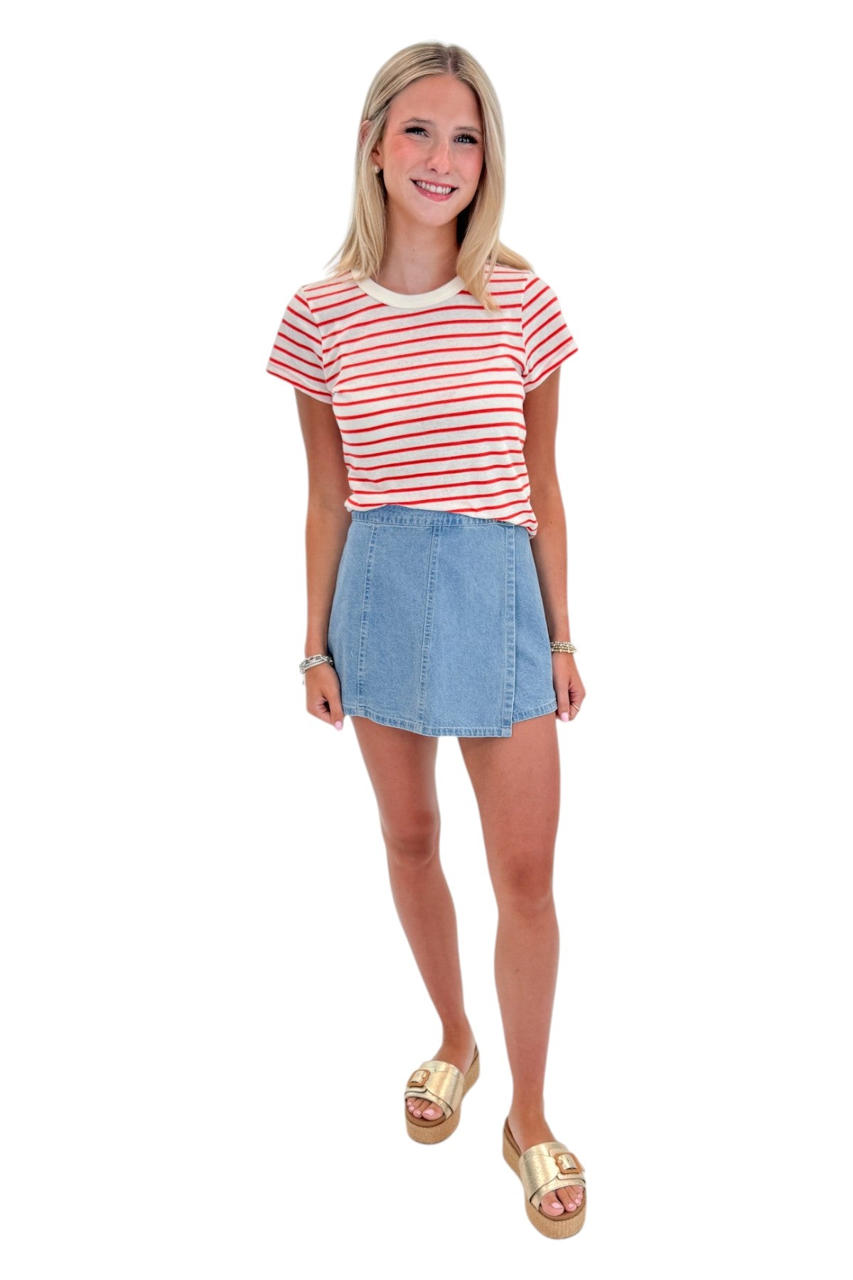 Front view of woman wearing Swagger Boutiqueās Lychee Junie Striped Tee by Z Supply with Light Wash Denim Wrap Skort against white studio background.