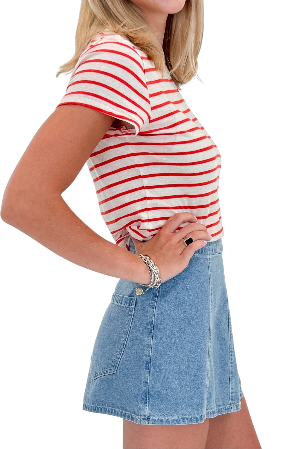 Side detail view of woman wearing Swagger Boutiqueās Lychee Junie Striped Tee by Z Supply with Light Wash Denim Wrap Skort against white studio background.