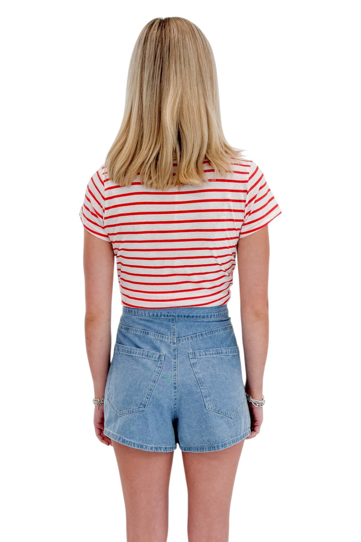 Back view of woman wearing Swagger Boutiqueās Lychee Junie Striped Tee by Z Supply with Light Wash Denim Wrap Skort against white studio background.