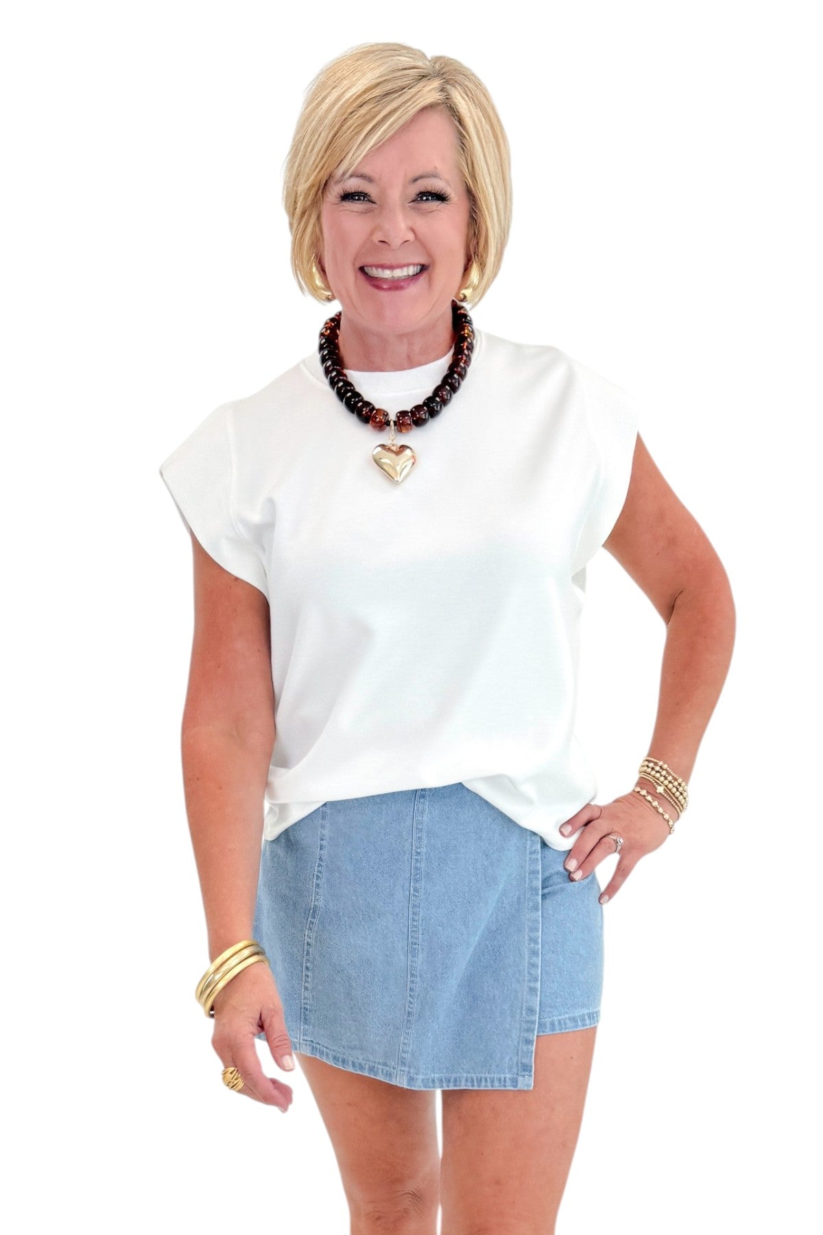 Front view of woman wearing Light Wash Denim Wrap Skort with white top against white studio background.
