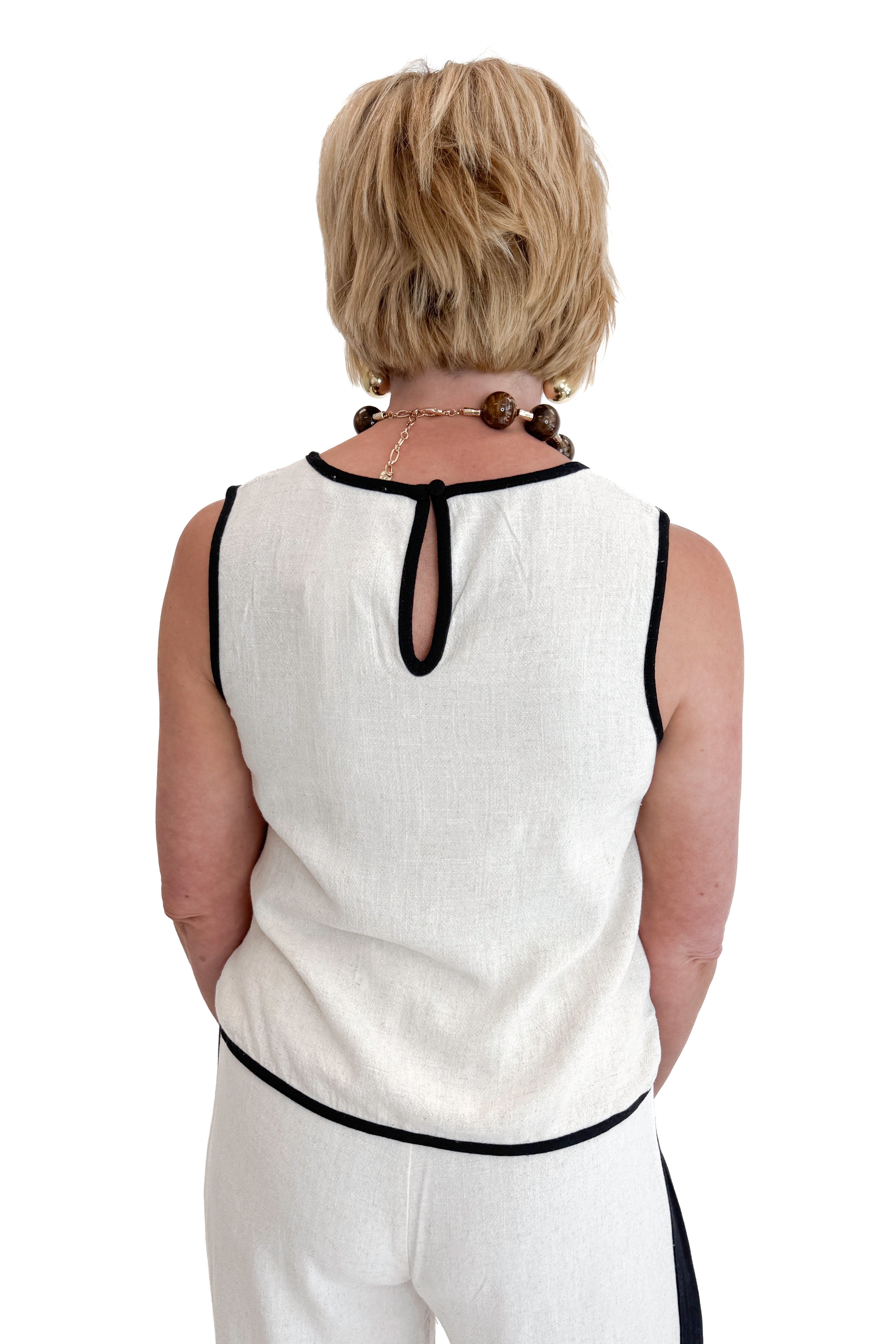 Back view of woman wearing Swagger Boutique’s Linen & Black Lined Tank with matching Linen & Black Stripe Pants against white studio background.