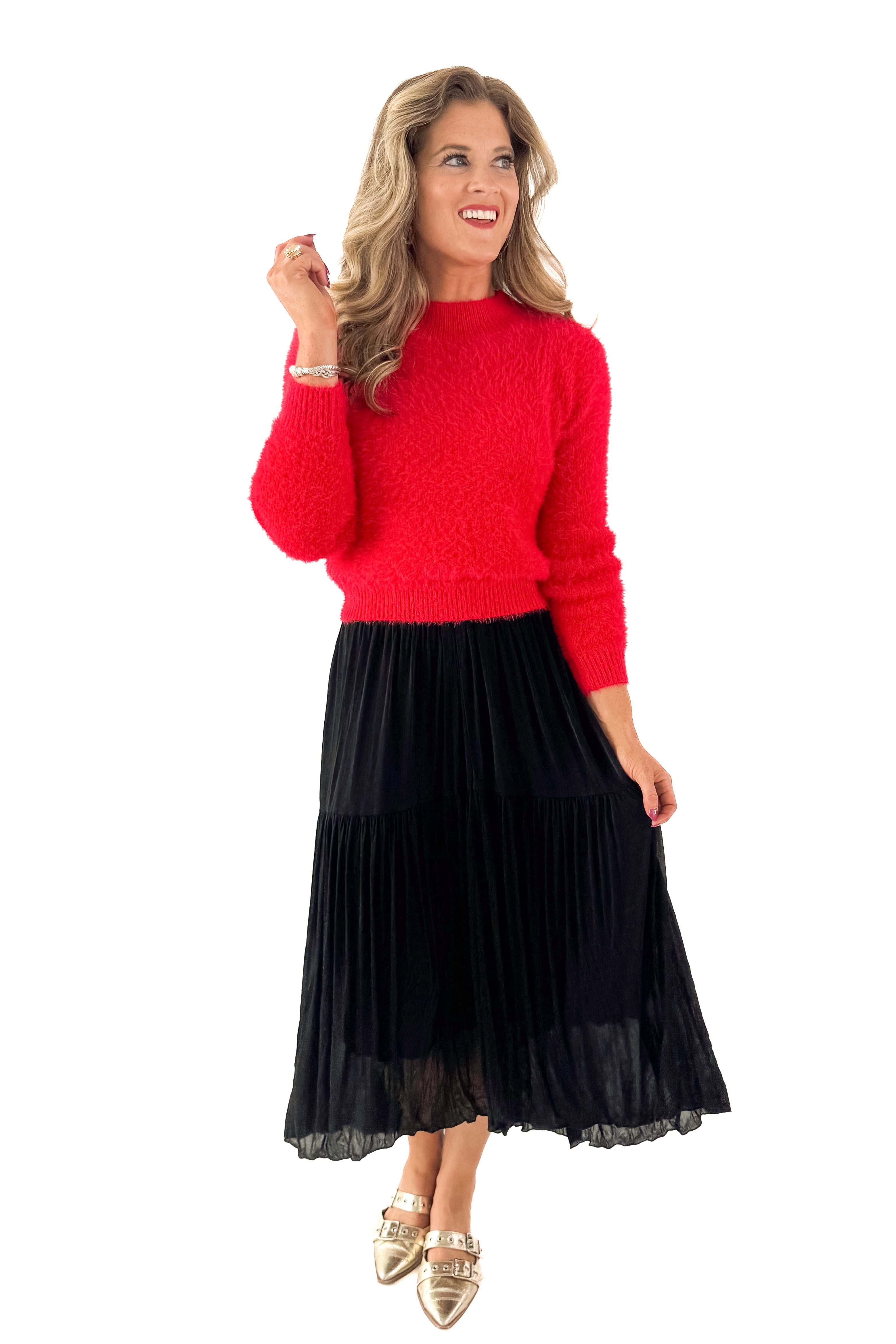 Front view of woman wearing Red Mock Neck Eyelash Sweater with black skirt against white studio background.