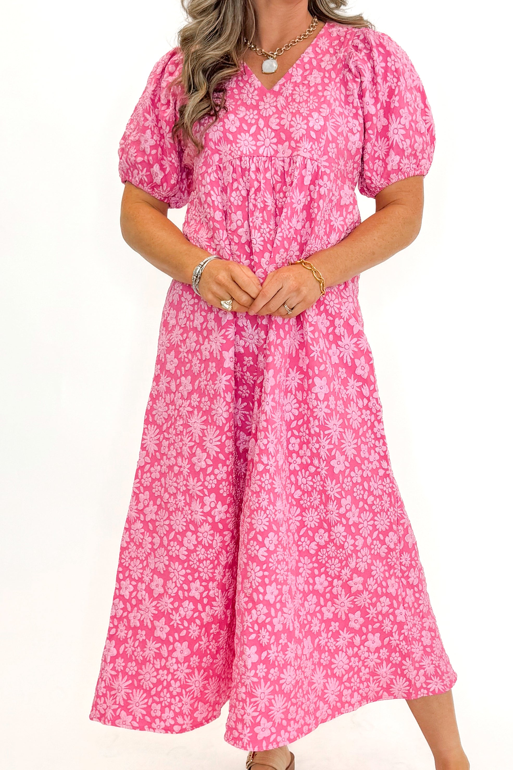 Front view of woman wearing Pink Floral Textured Puff Sleeve Midi Dress against white studio background.