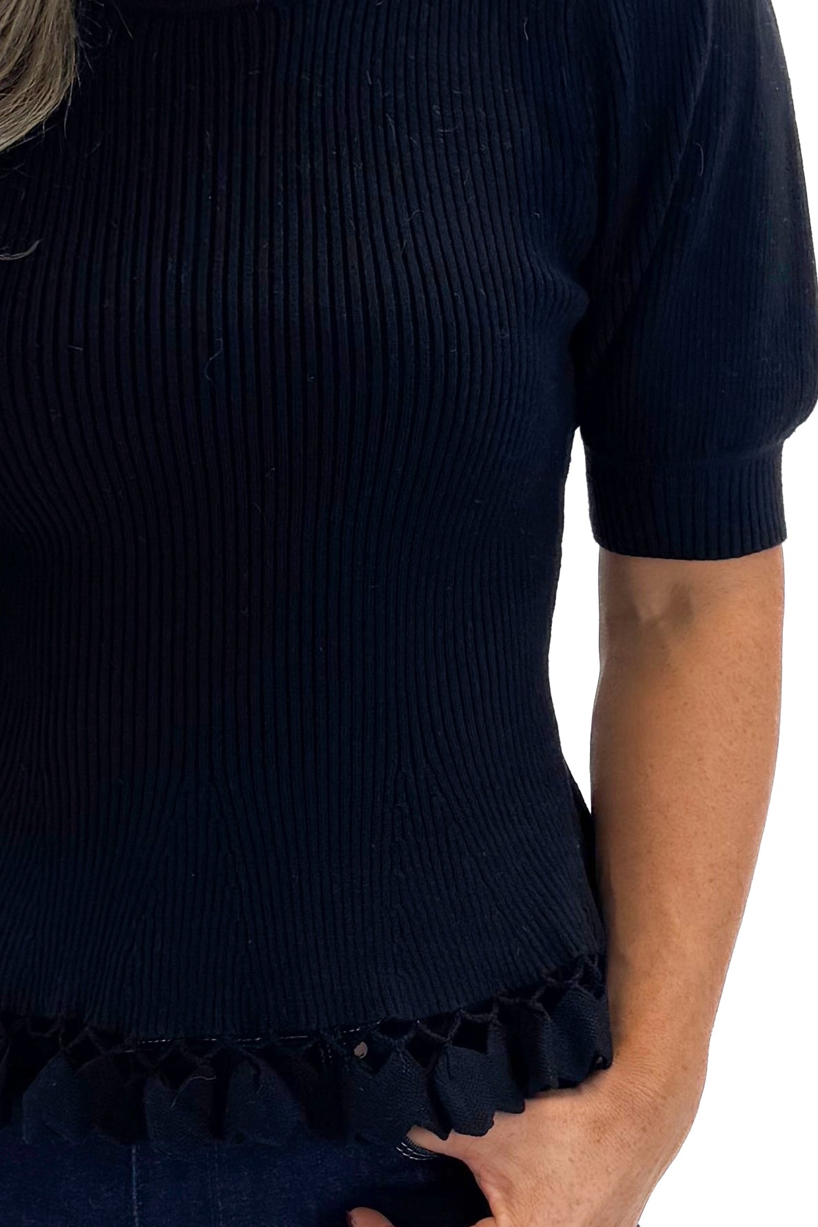Front detail view of woman wearing Black Ribbed Trim Detail Top with jeans against white studio background.