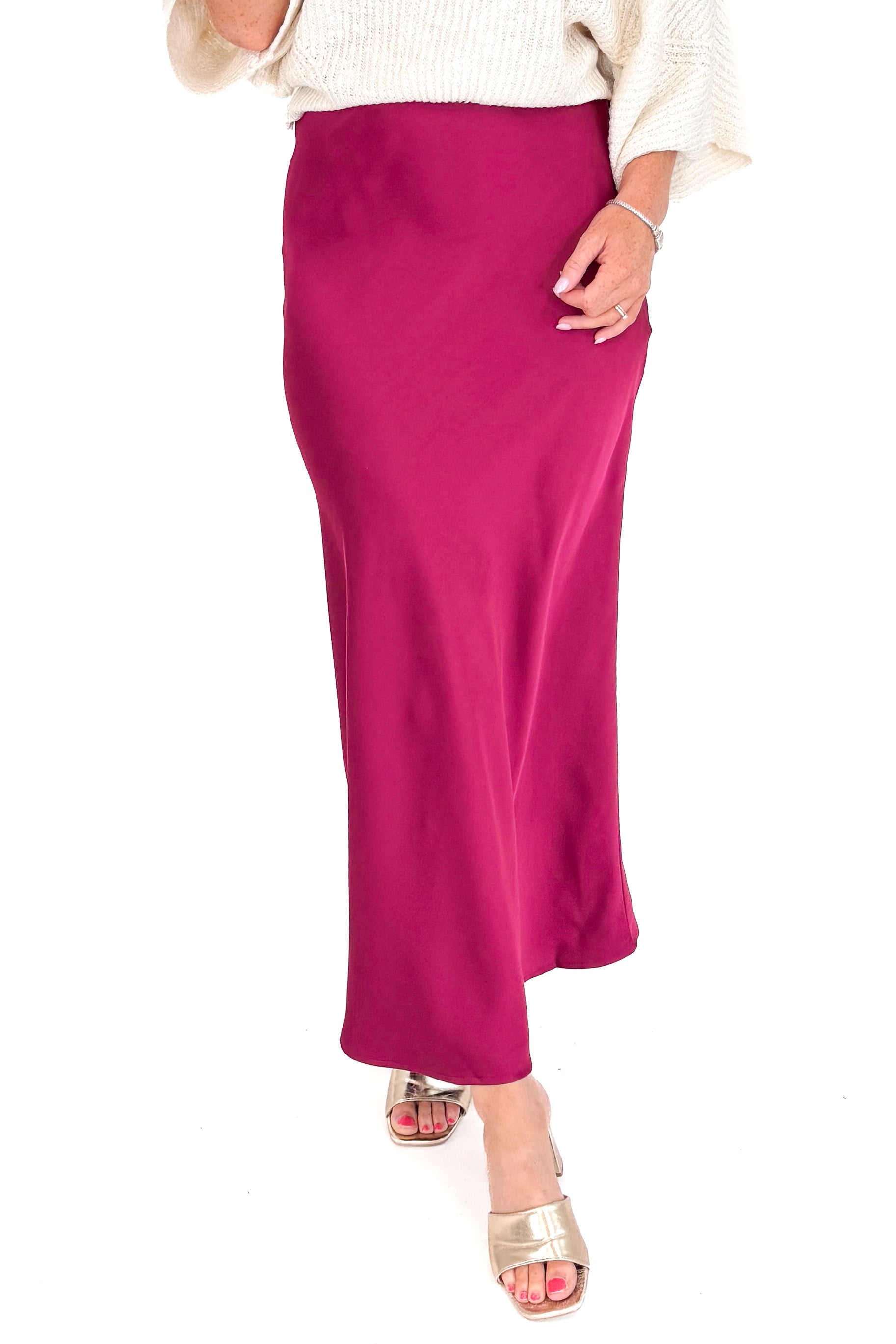 Maroon skirt worn by a person on a white background