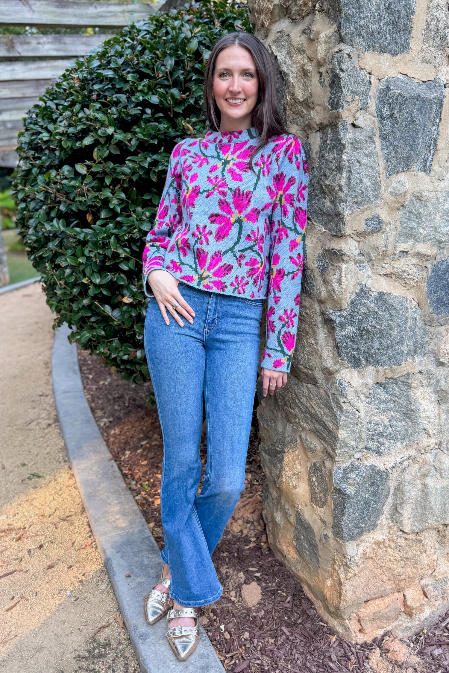 A Cut Above blue and pink floral printed sweater - full length model shot outside learning