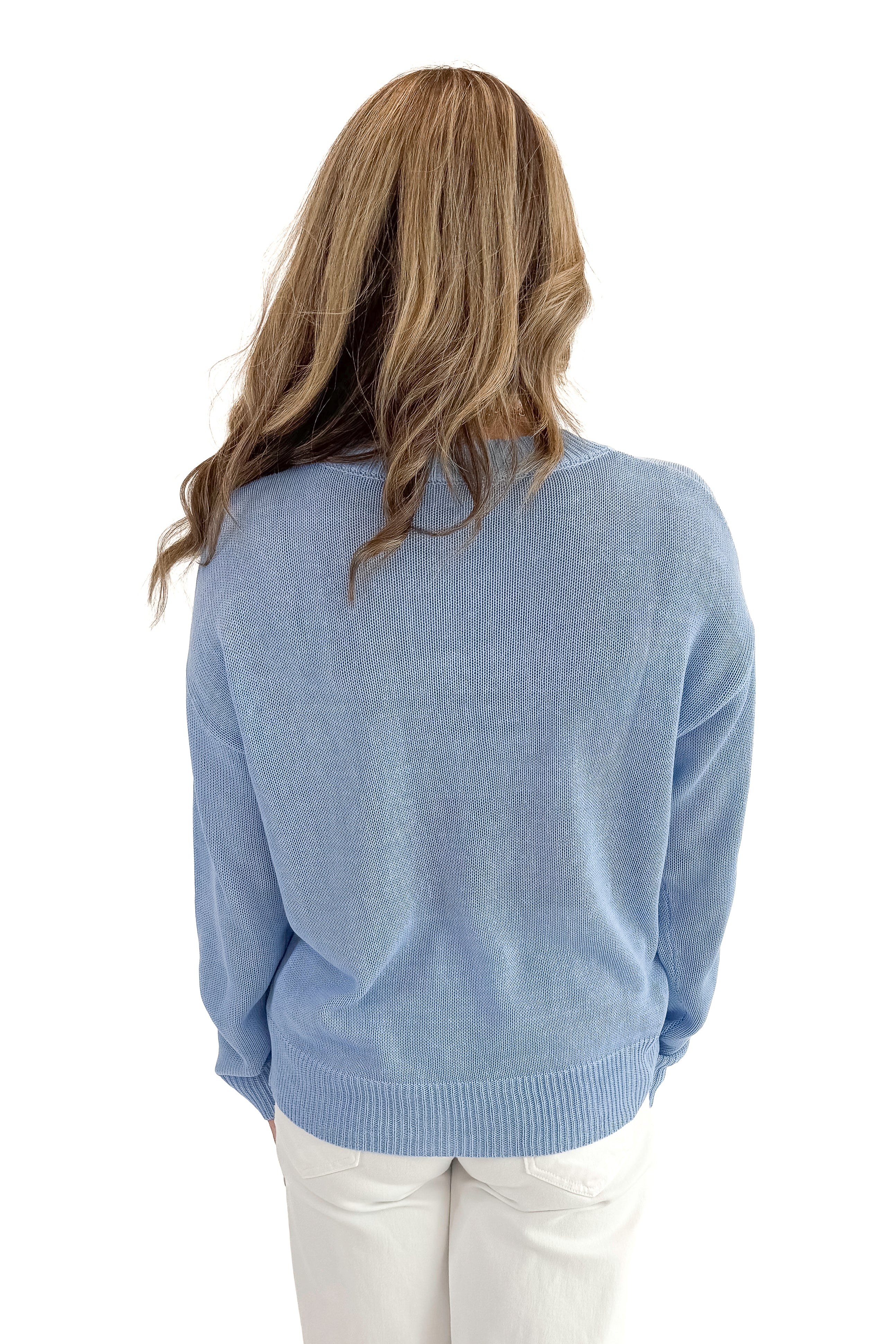 Back view of woman wearing Blue Lobster Graphic Sweater with jeans against white studio background.