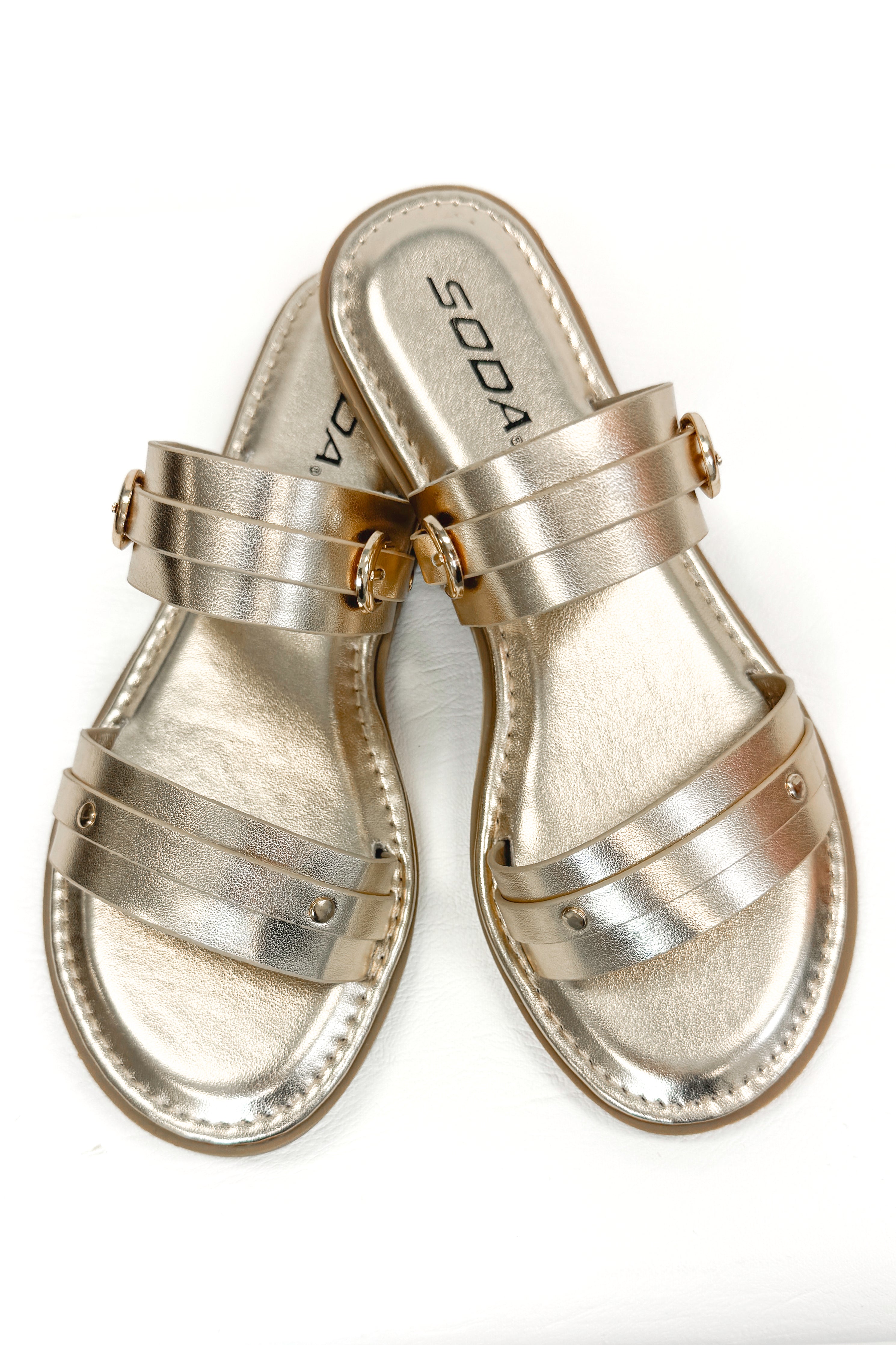 Maya- Gold Double Strap Buckle Detail Sandals against white studio background