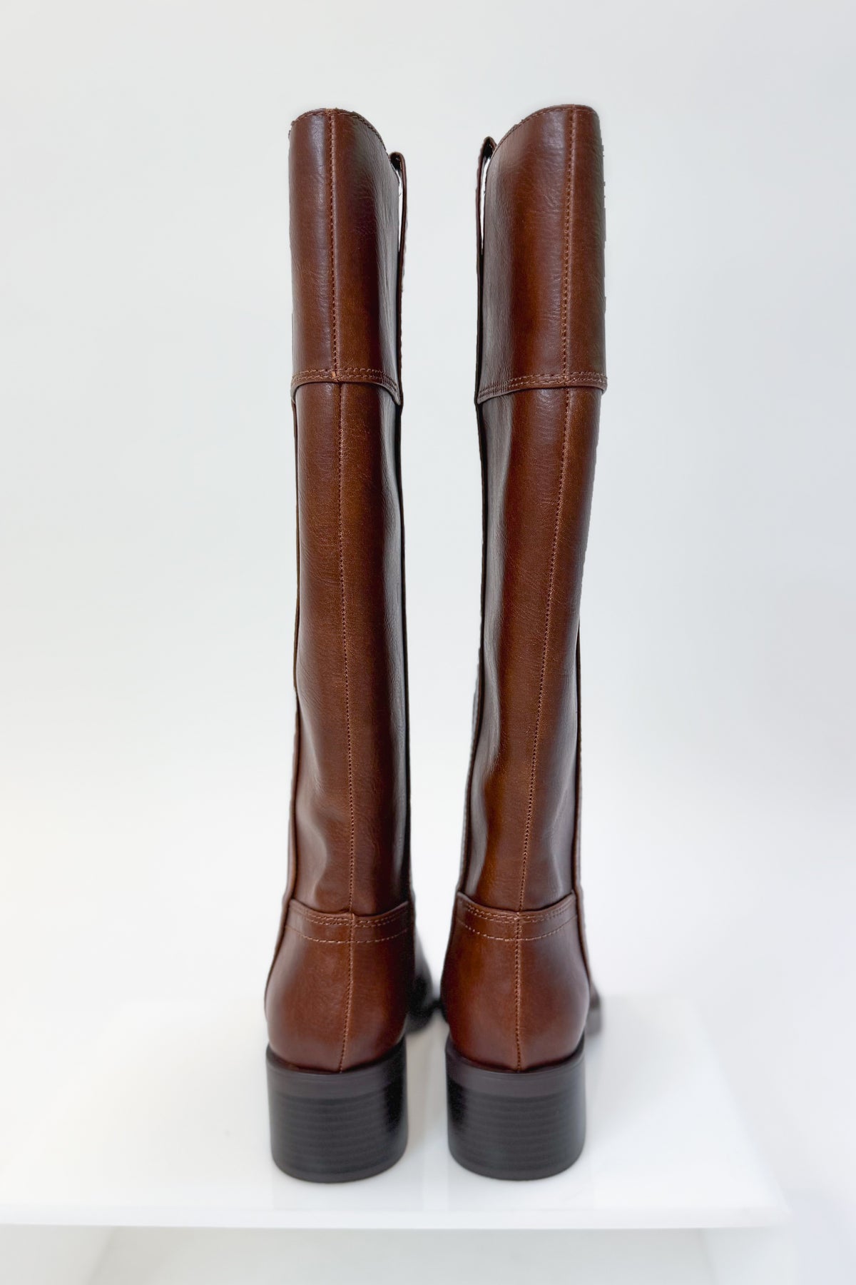 Mizell- Brown Tall Boots against white studio background back view.