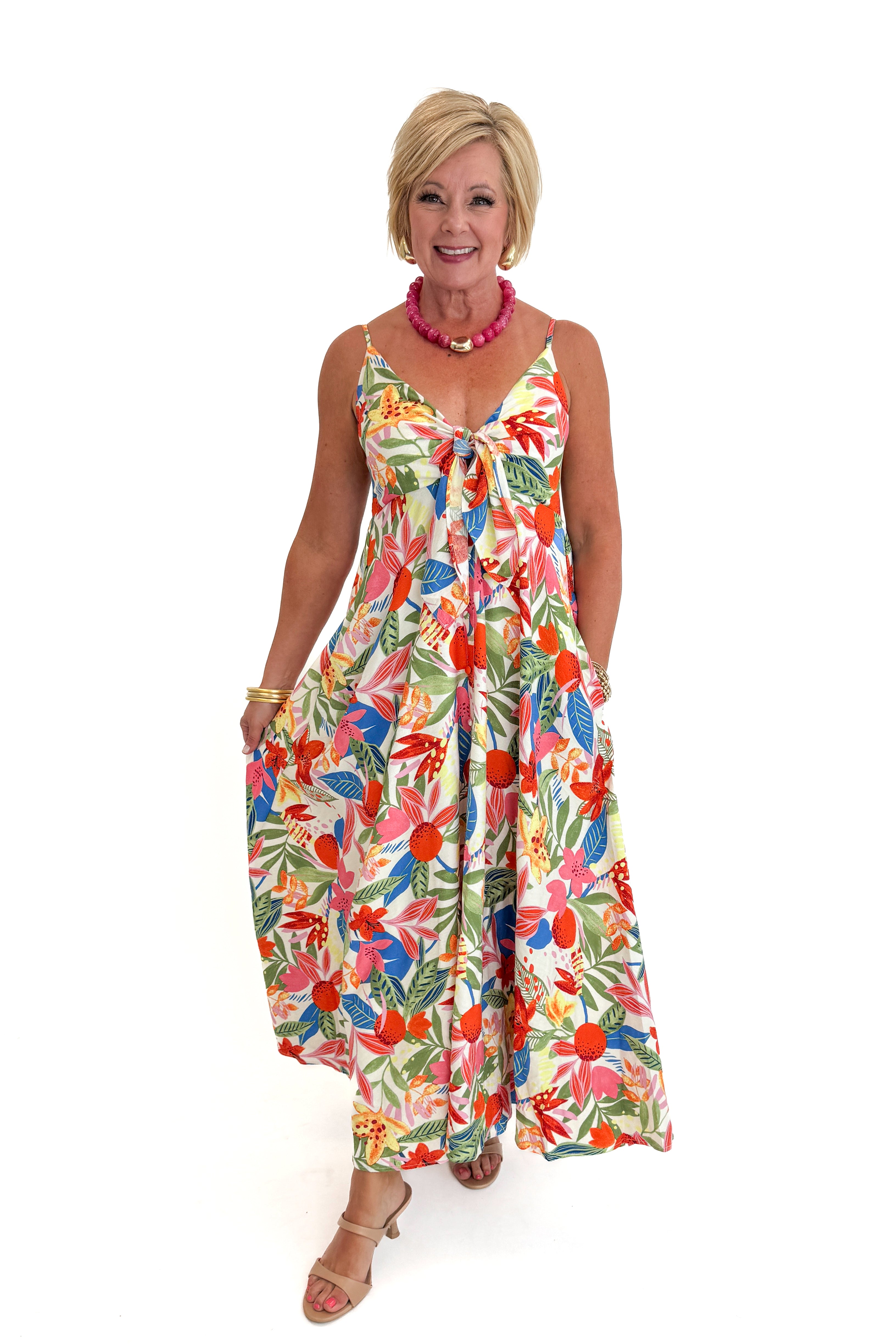 Front view of woman wearing Swagger Boutiqueβs Multi Floral Midi Dress against white studio background.