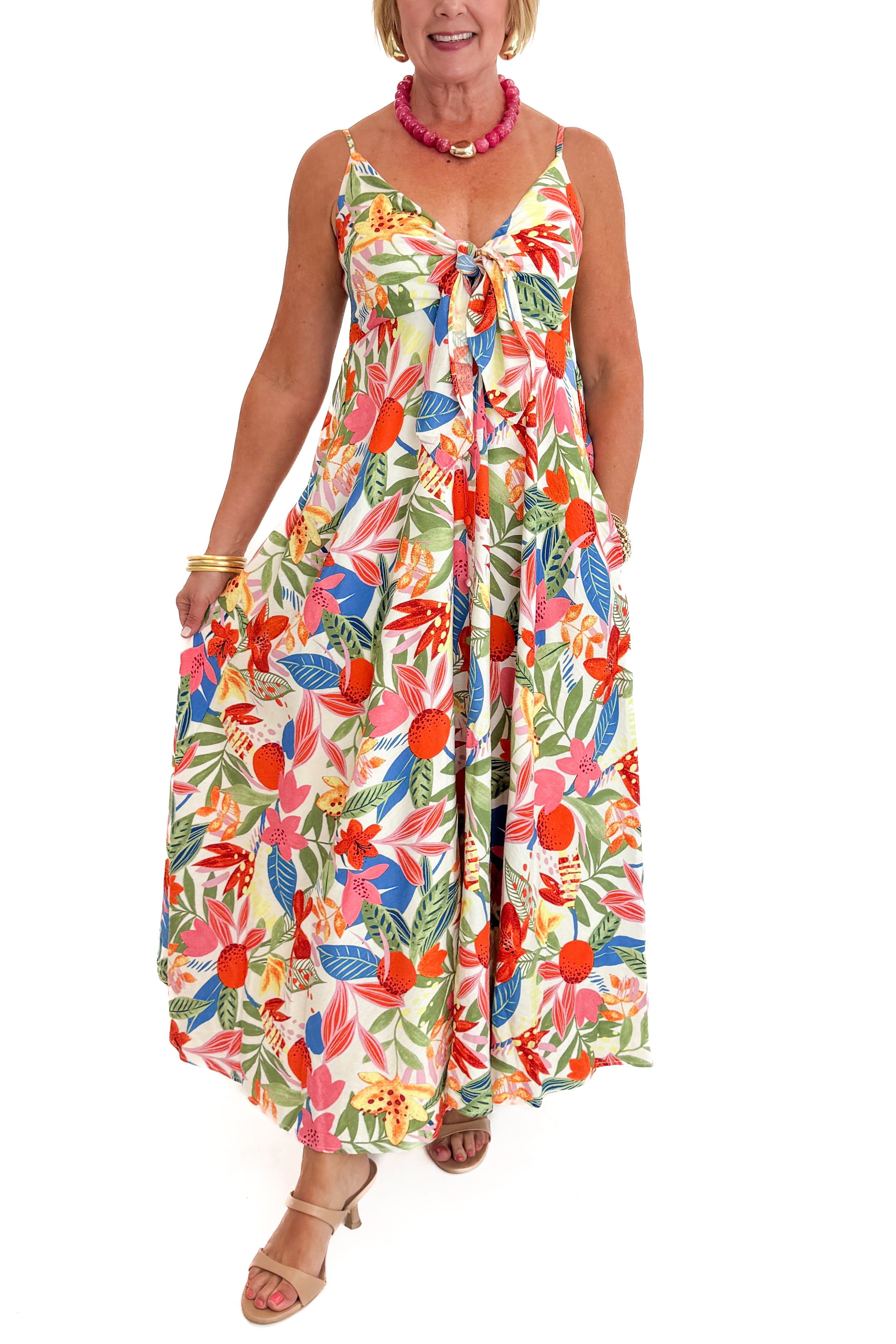 Front view of woman wearing Swagger Boutiqueβs Multi Floral Midi Dress against white studio background.