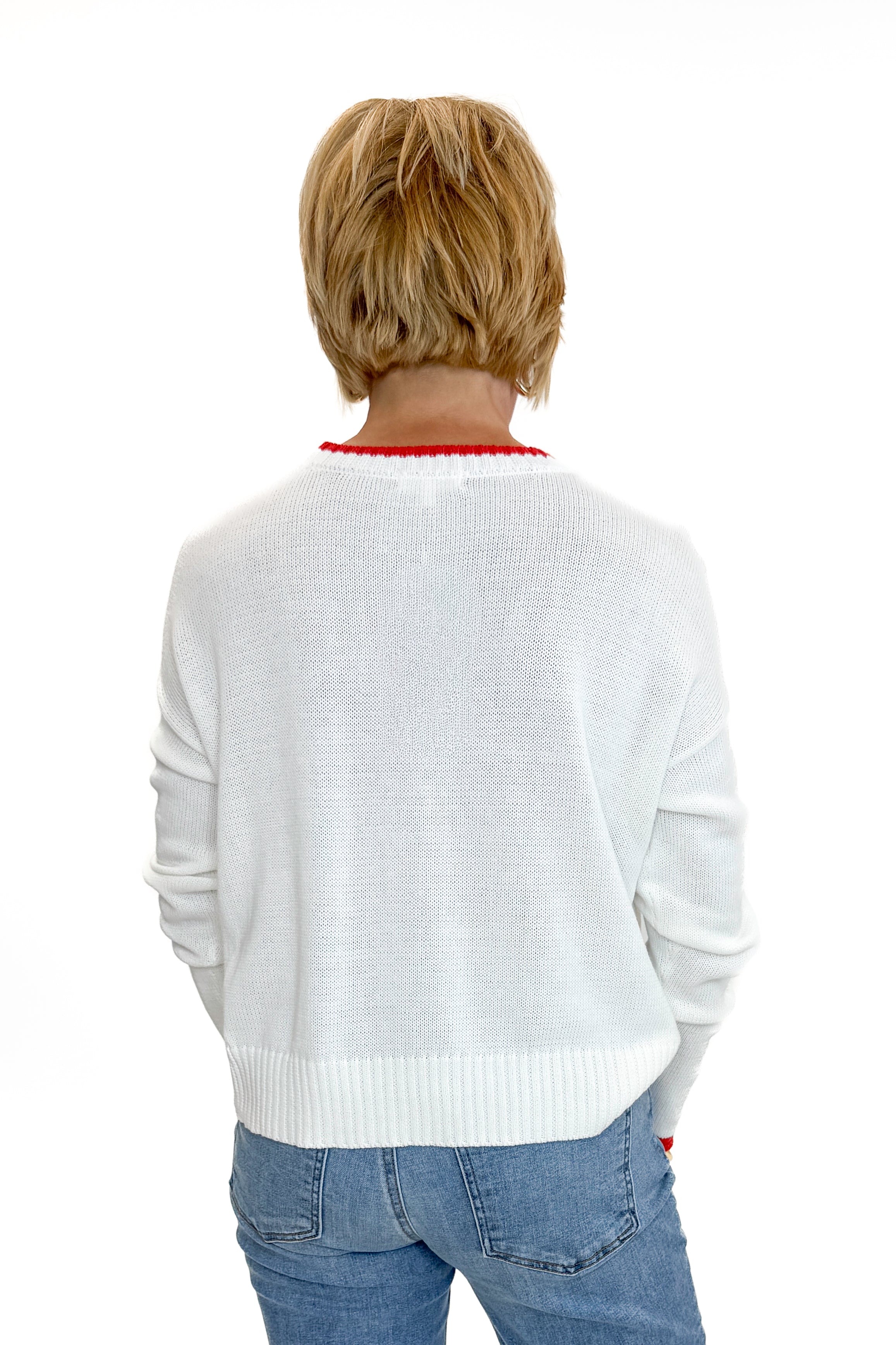 Back view of woman wearing Swagger Boutique’s Multi Seas The Day Sienna Sweater by Z Supply with jeans against white studio background.