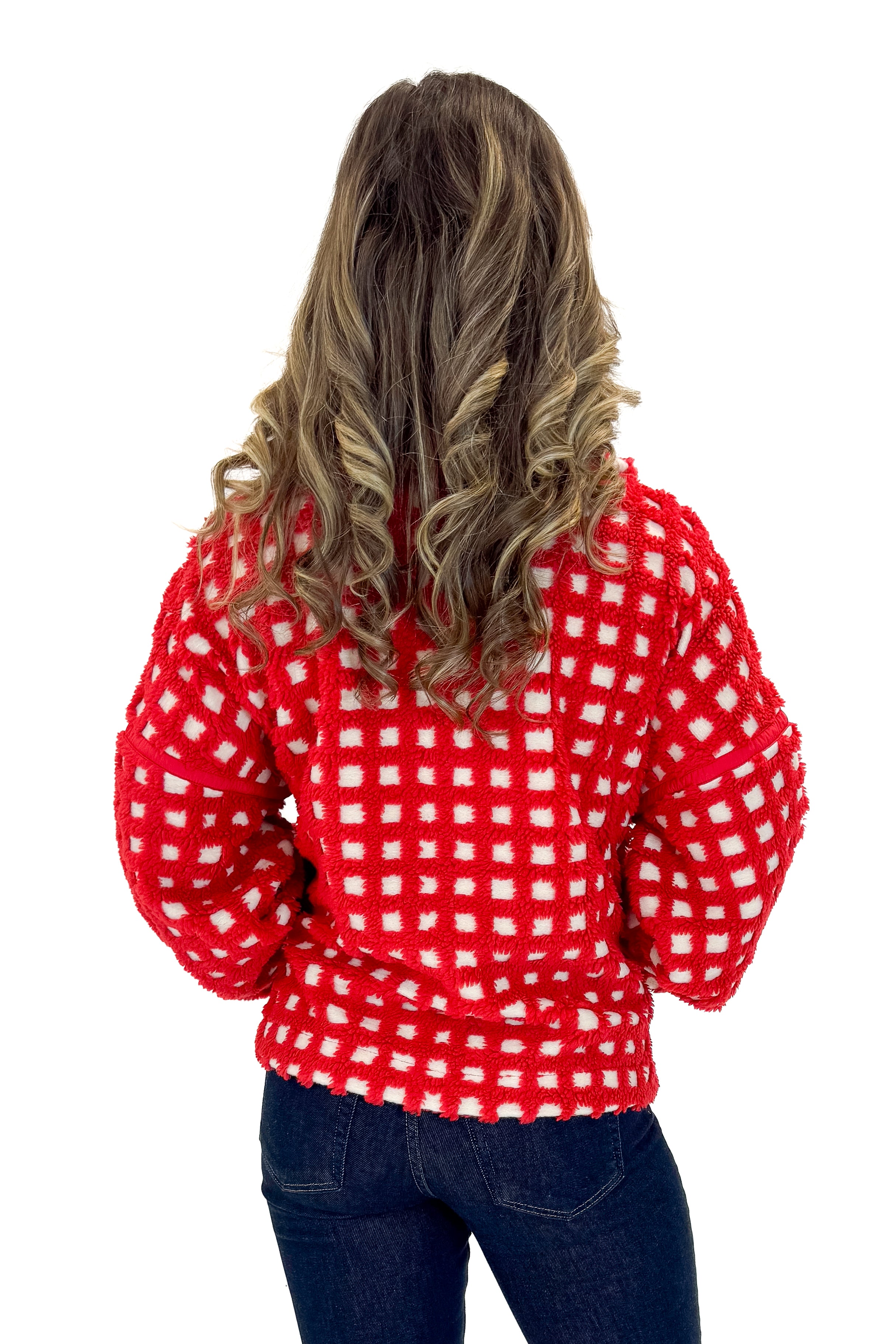 Back view of woman wearing Red & Cream Checkered Sherpa Jacket with jeans against white studio background.