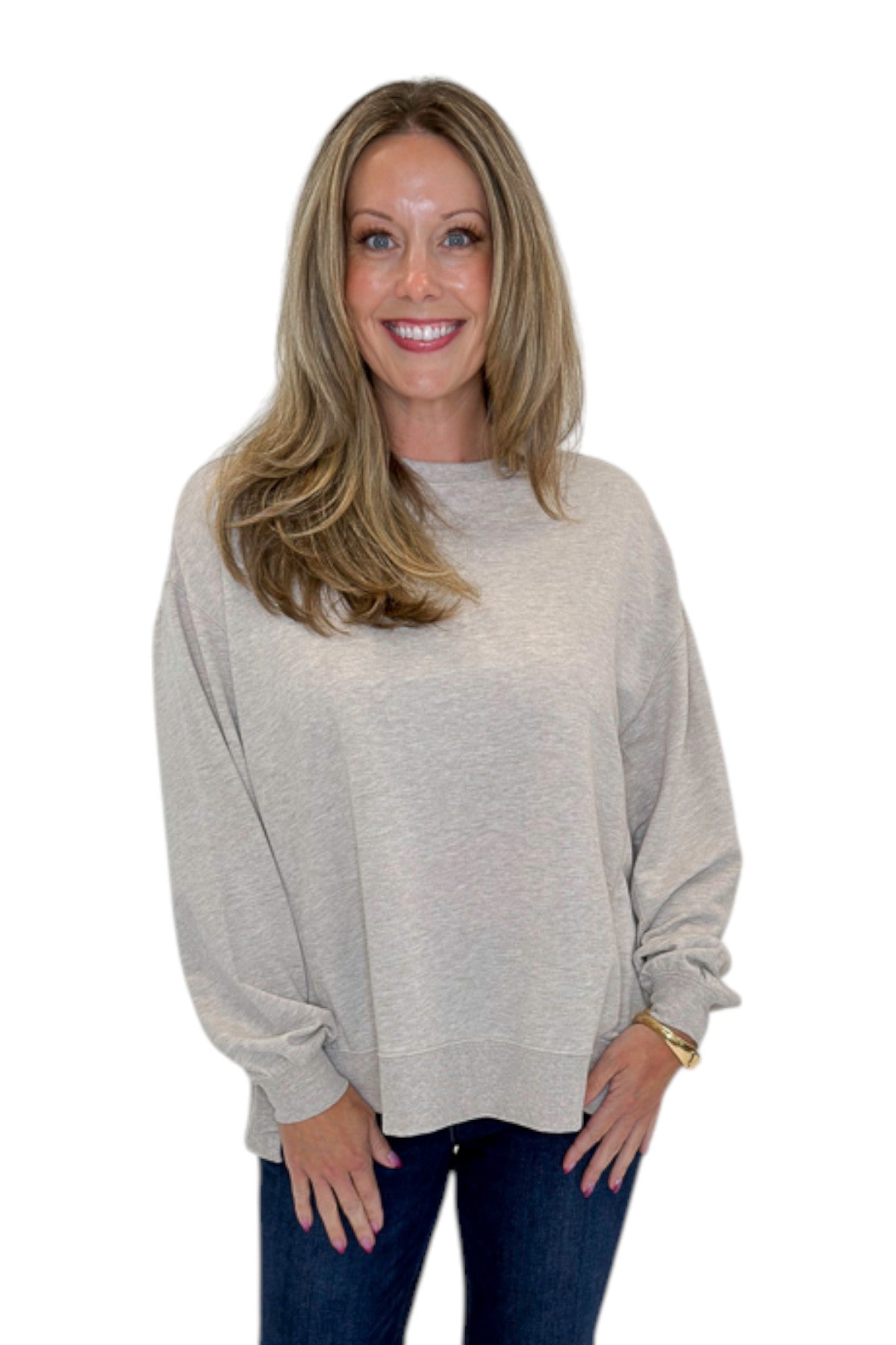 Front view of woman wearing Swagger Boutiqueās Natural Heather Modern Weekender by Z Supply with jeans against white studio background.