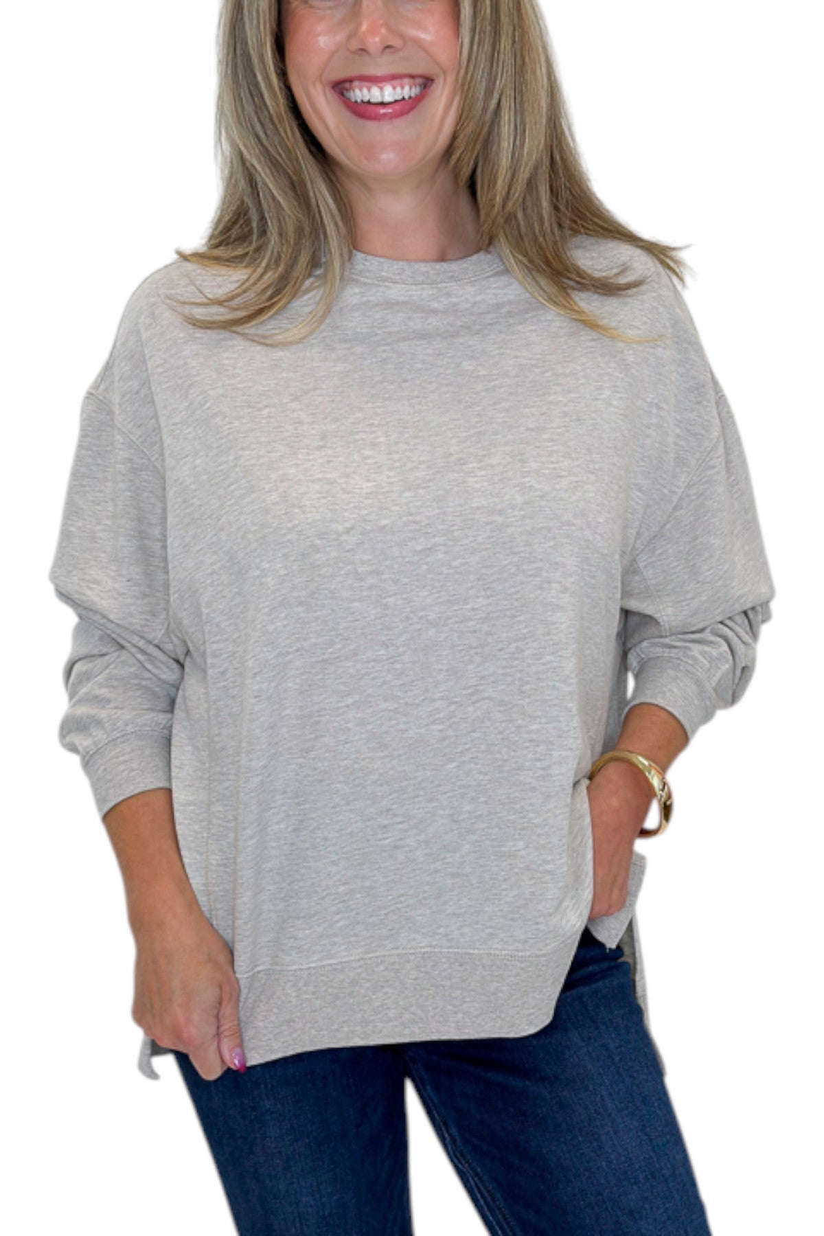 Front detail view of woman wearing Swagger Boutiqueās Natural Heather Modern Weekender by Z Supply with jeans against white studio background.