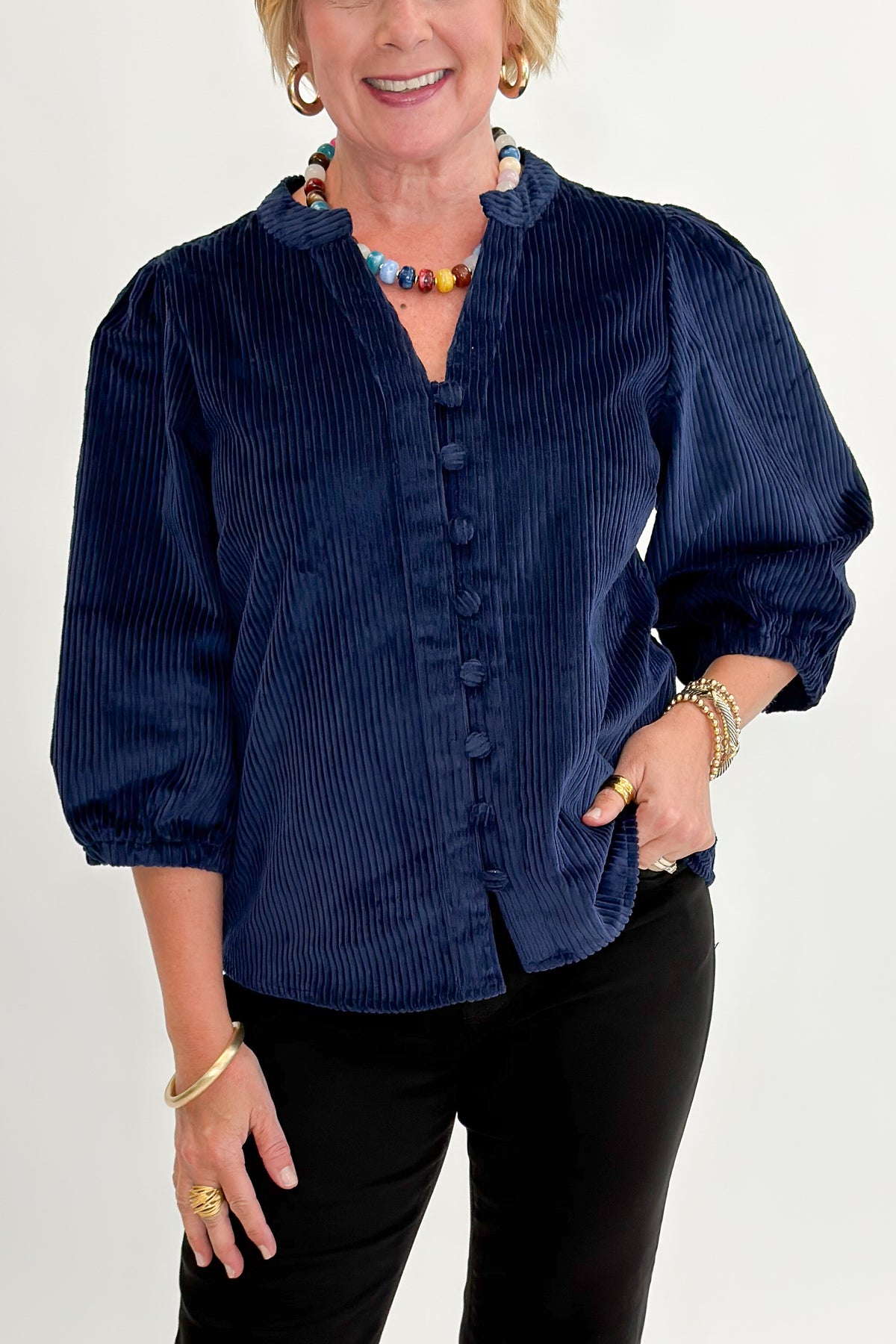 Front detail view of woman wearing Swagger Boutique’s Navy Corduroy Half Sleeve Top with jeans against white studio background.