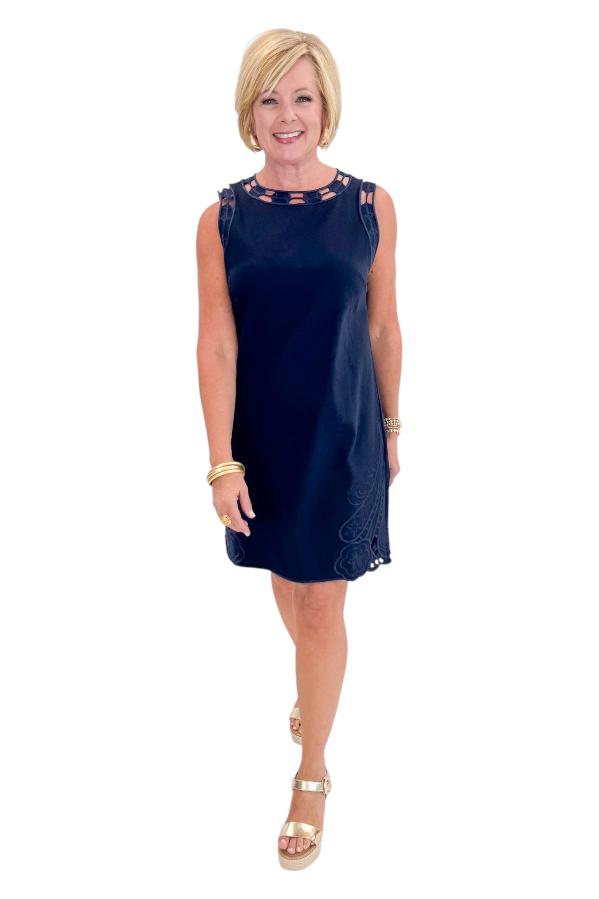 Front view of woman wearing Swagger Boutiqueās Navy Embroidered Trim Mini Dress with sandals against white studio background.