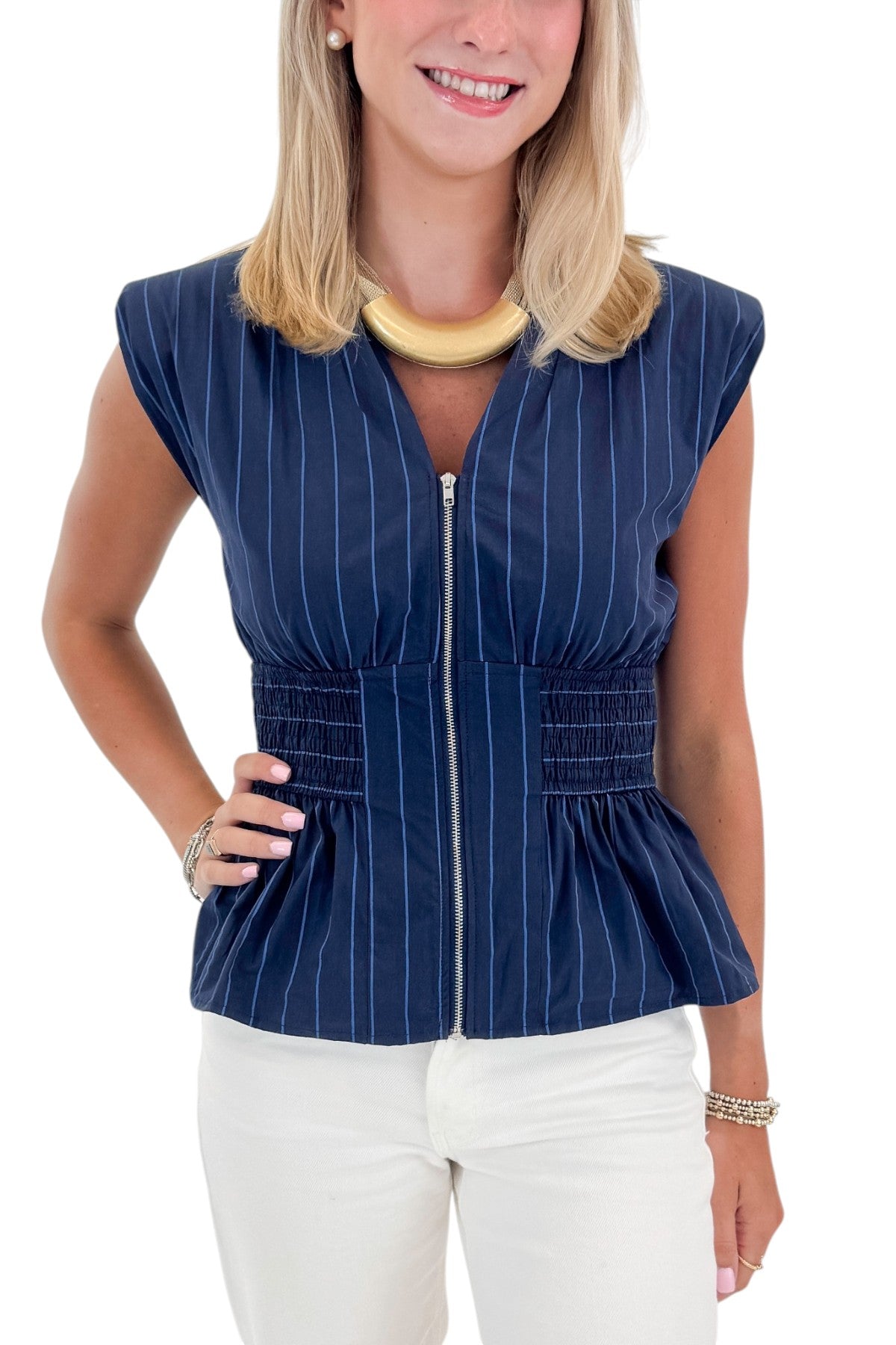 Front detail view of woman wearing Swagger Boutique’s Navy Striped Peplum Tank with jeans against white studio background.