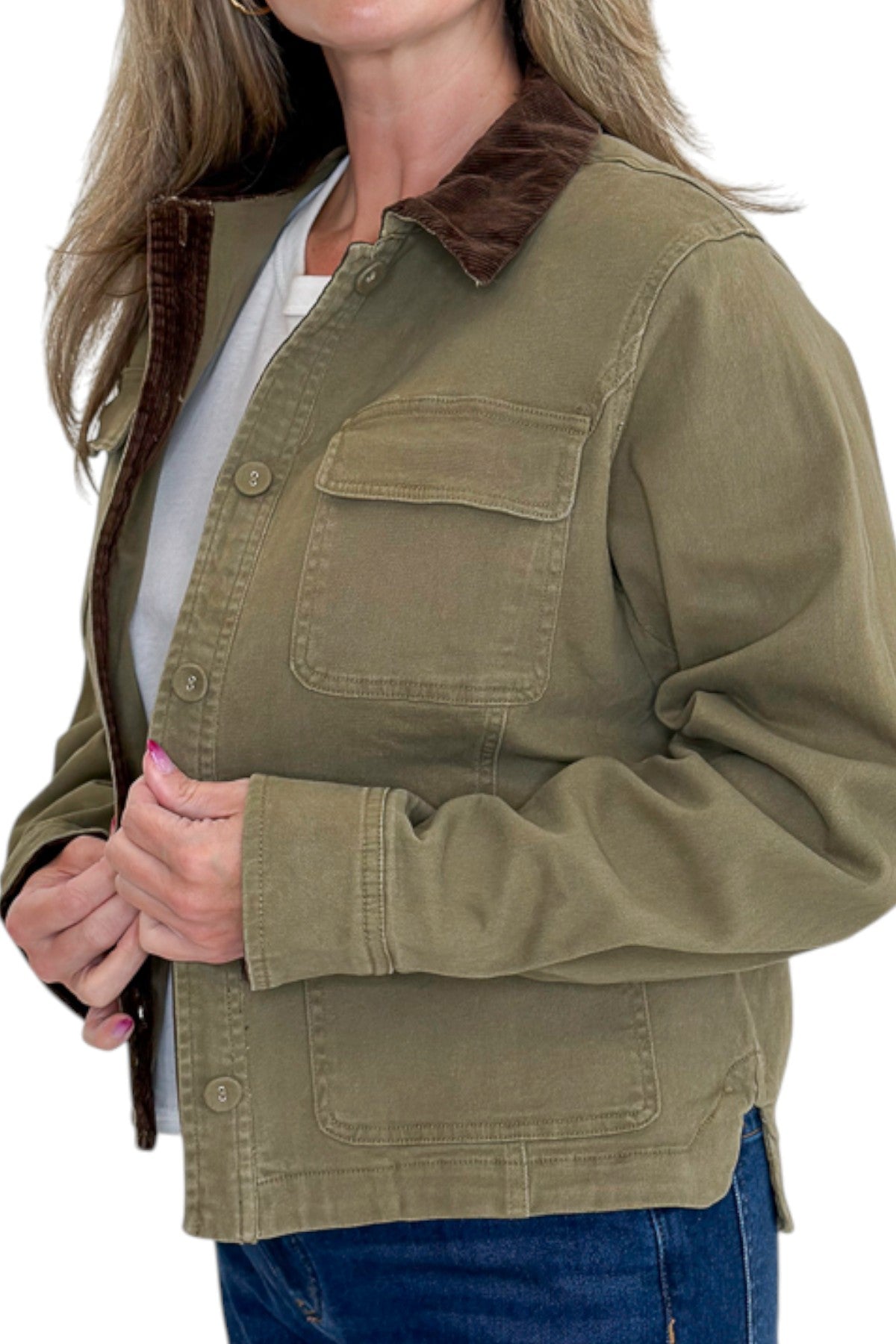 Side detail view of woman wearing Swagger Boutiqueβs Olive Barn Jacket With Corduroy Collar with jeans against white studio background.