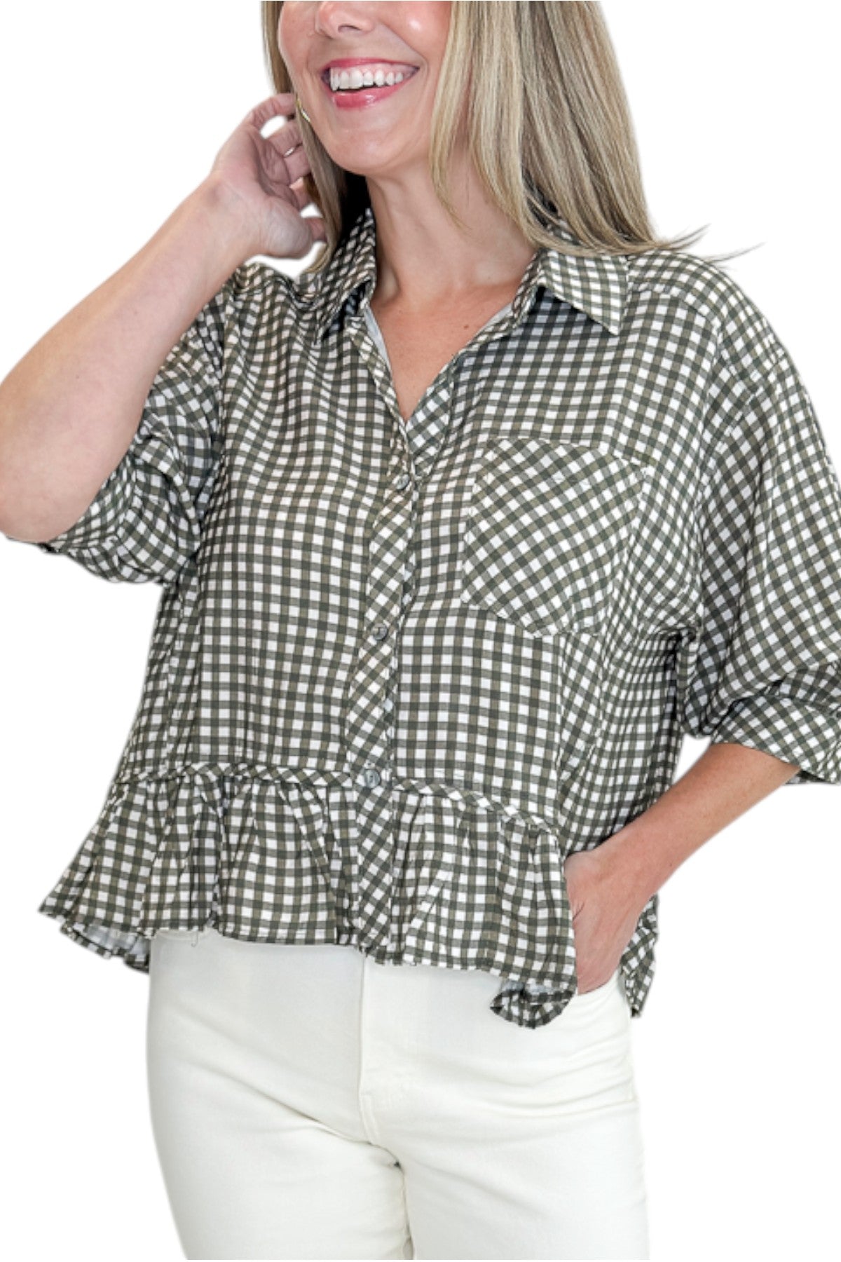 Front detail view of woman wearing Swagger Boutiqueβs Olive Gingham Peplum Top by Entro with jeans against white studio background.